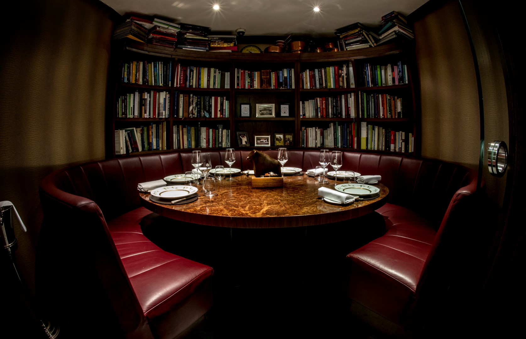 Intimate meeting space with round table and leather seating at The Kitchen Library, Mayfair.