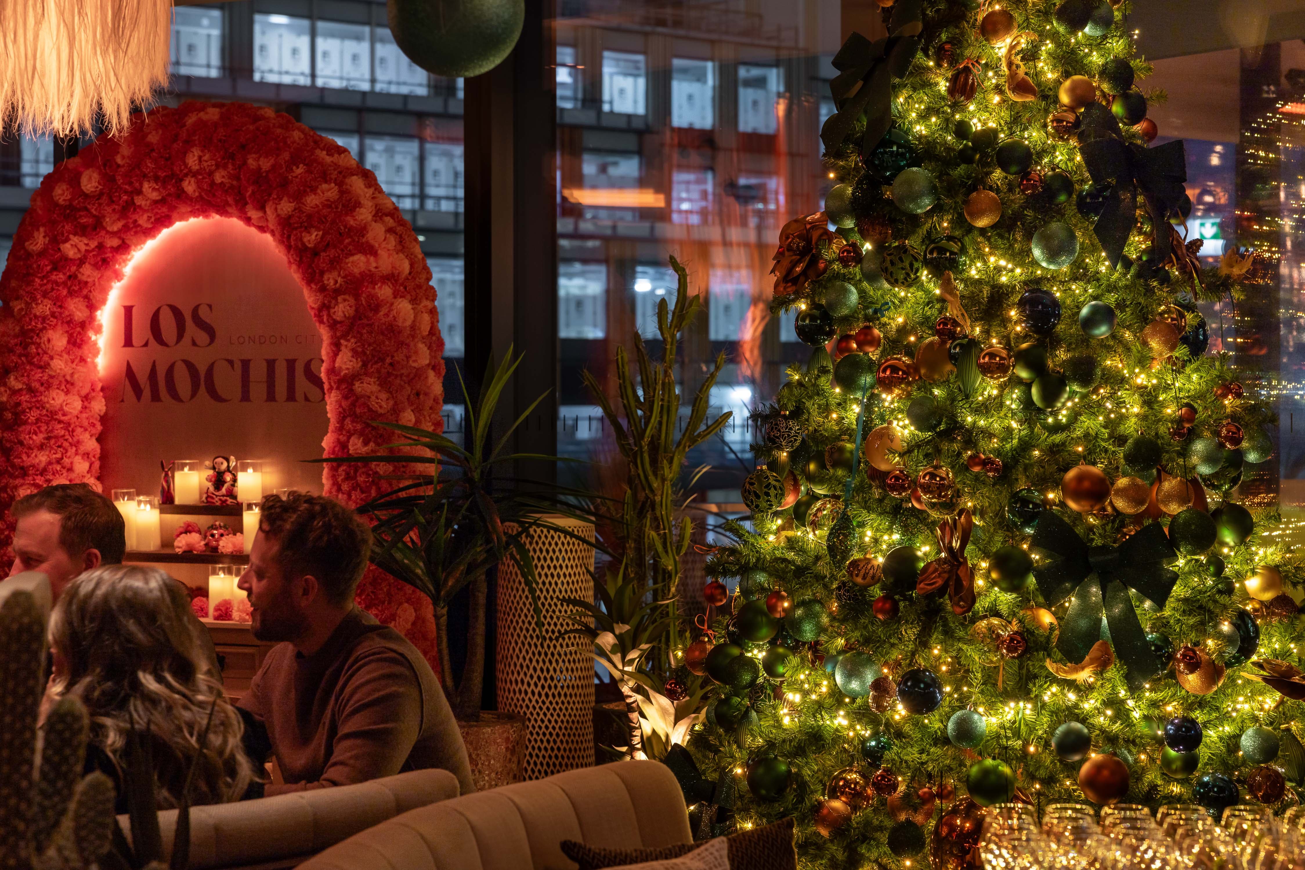 Private dining room with festive floral decor for corporate holiday events and seasonal parties.