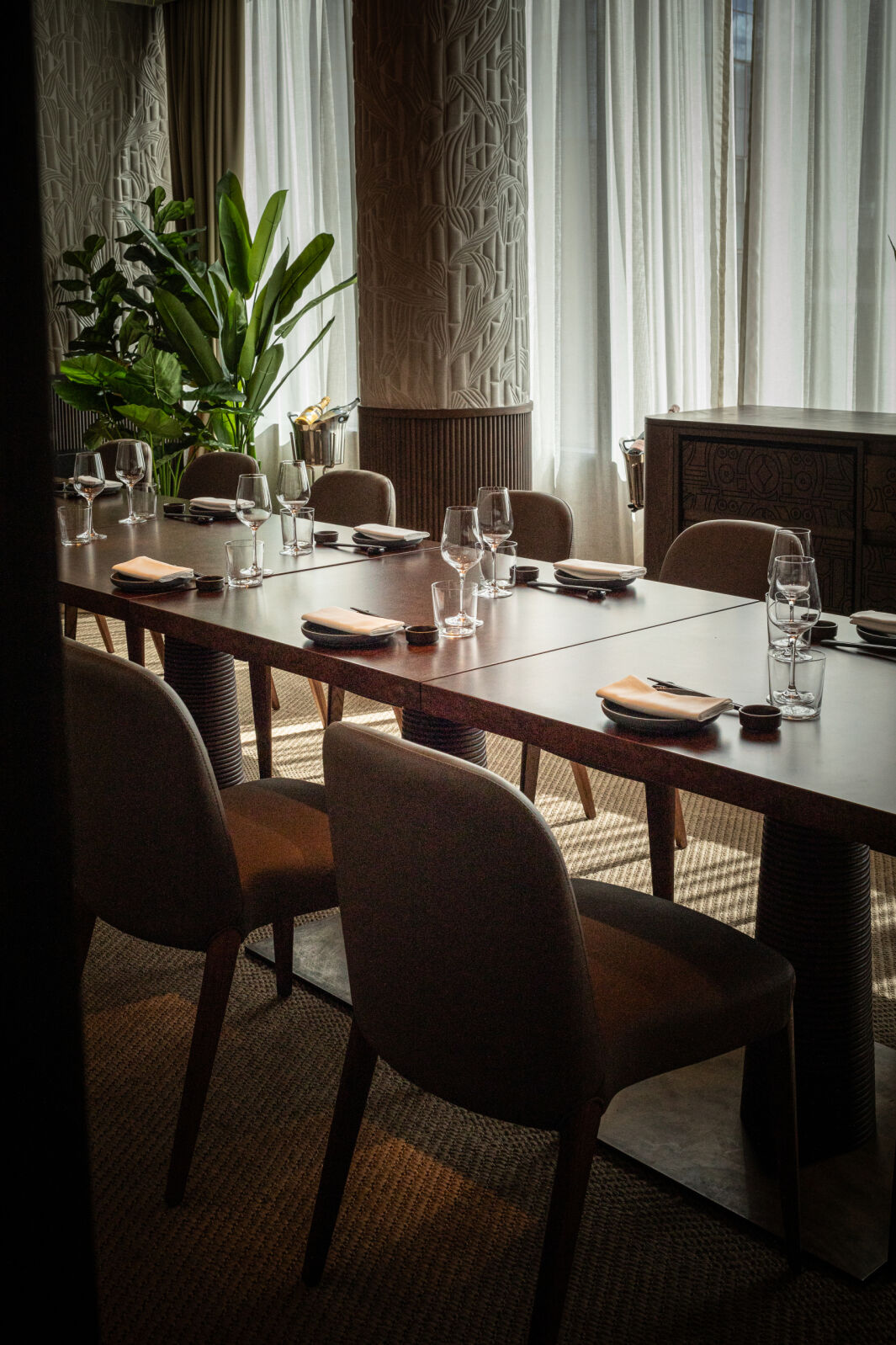 Private dining room with long wooden table, ideal for exclusive events in London.