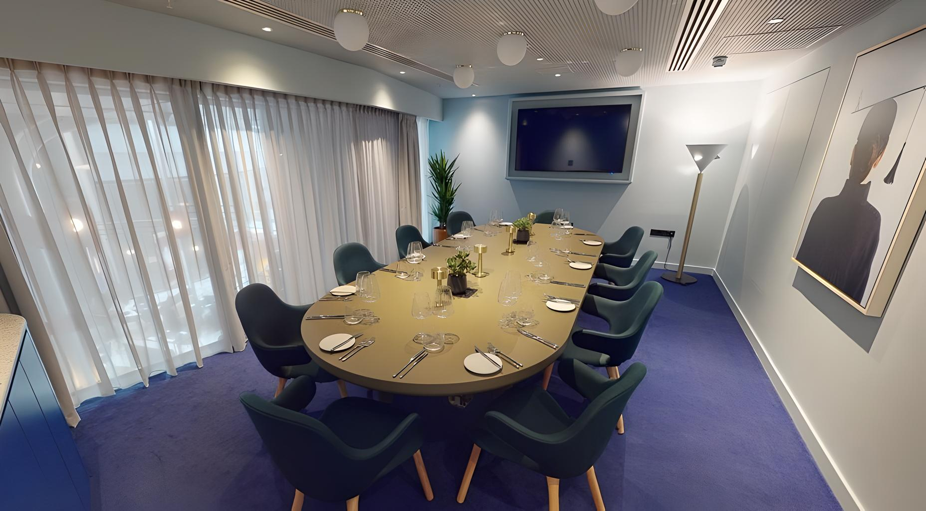 Modern meeting room with oval table, ideal for corporate events and brainstorming sessions.