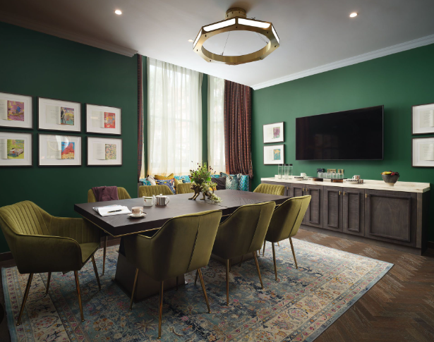 Mervyn Peake in a stylish meeting room with green walls for intimate gatherings.