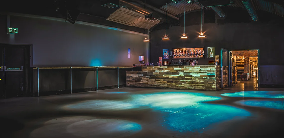 Modern event space with stylish bar, ideal for networking and social gatherings.