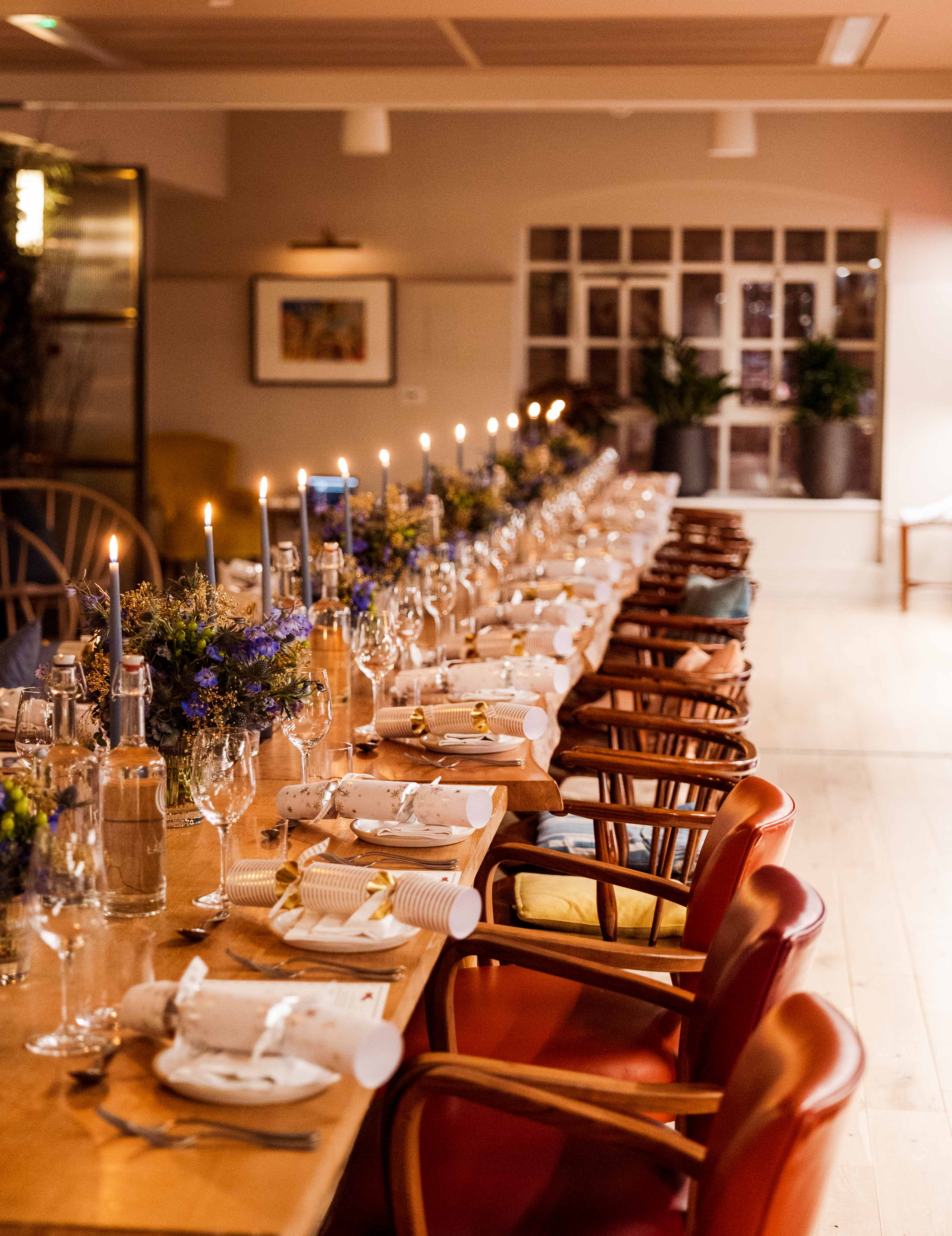 Elegant dining table setup with candlelight for a cozy dinner party event.
