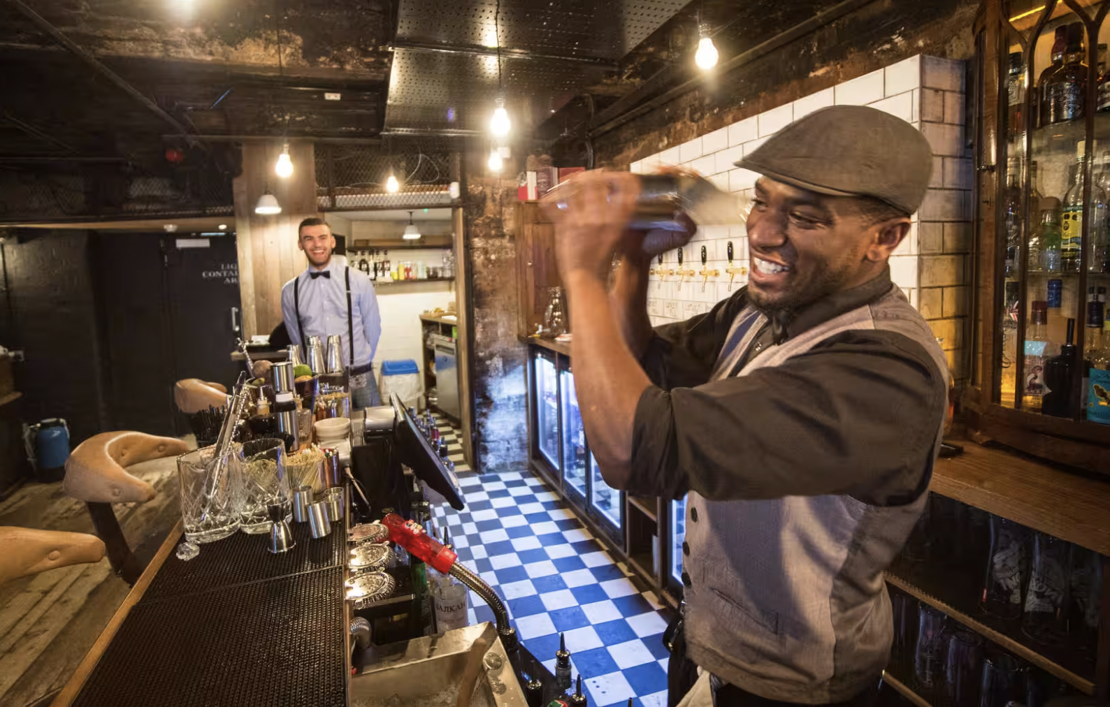 Energetic bartender mixing drinks at WN Barkers, ideal for networking events and cocktail receptions.