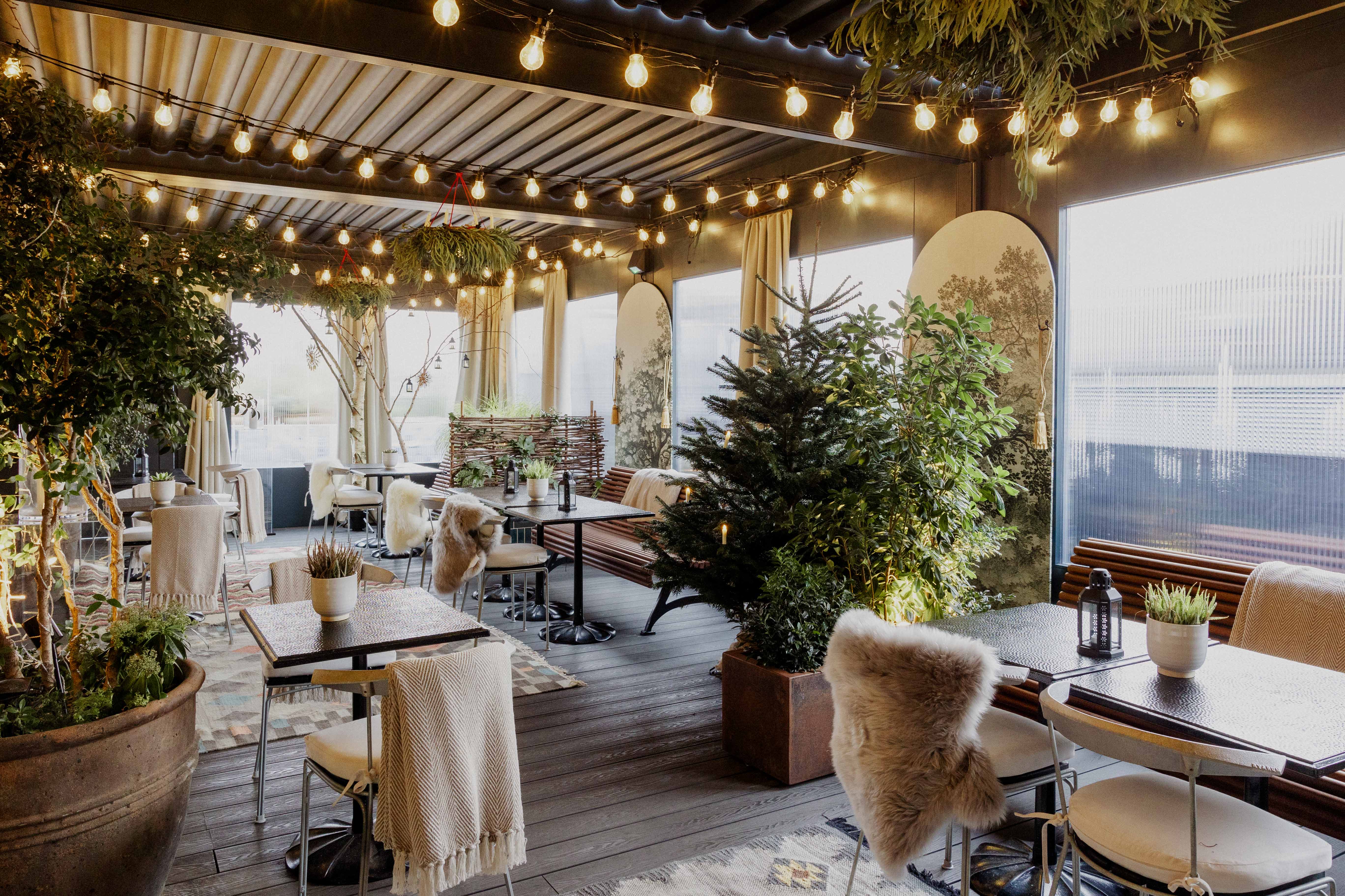 The Pergola in The Conduit: cozy event space with string lights for gatherings.