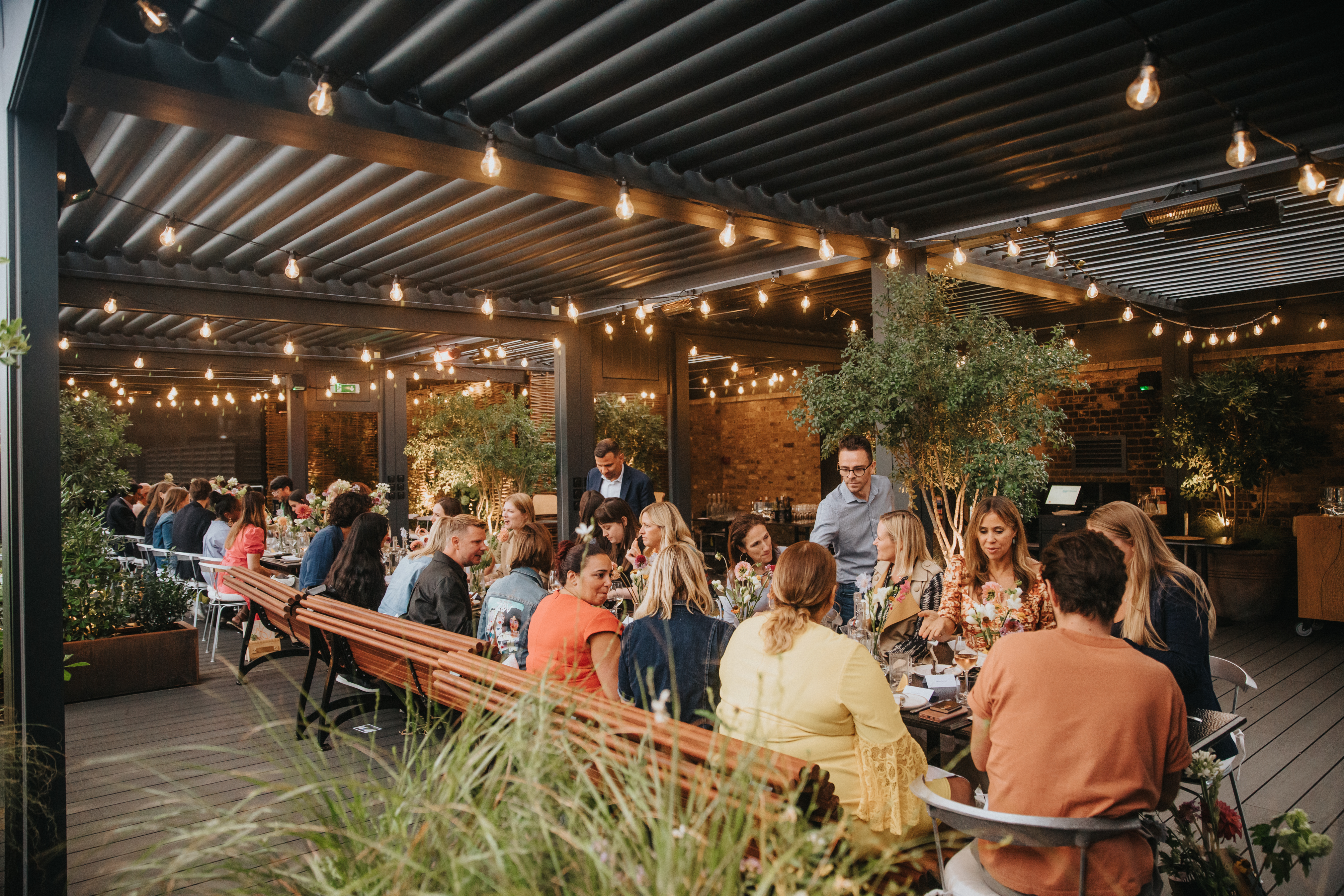 Vibrant outdoor event space with string lights for networking and social gatherings.