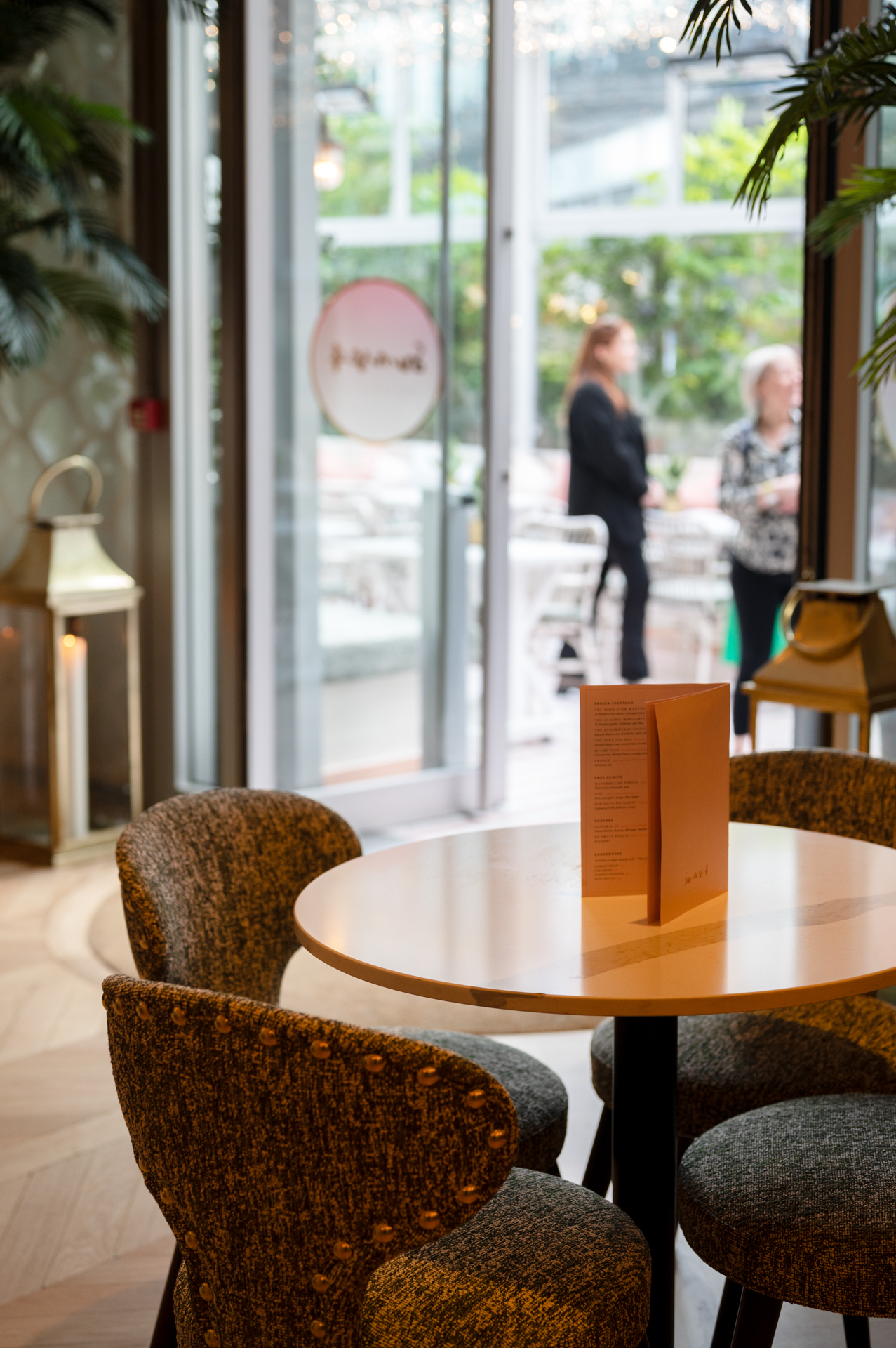 Vibrant event space with greenery, ideal for networking and social gatherings.