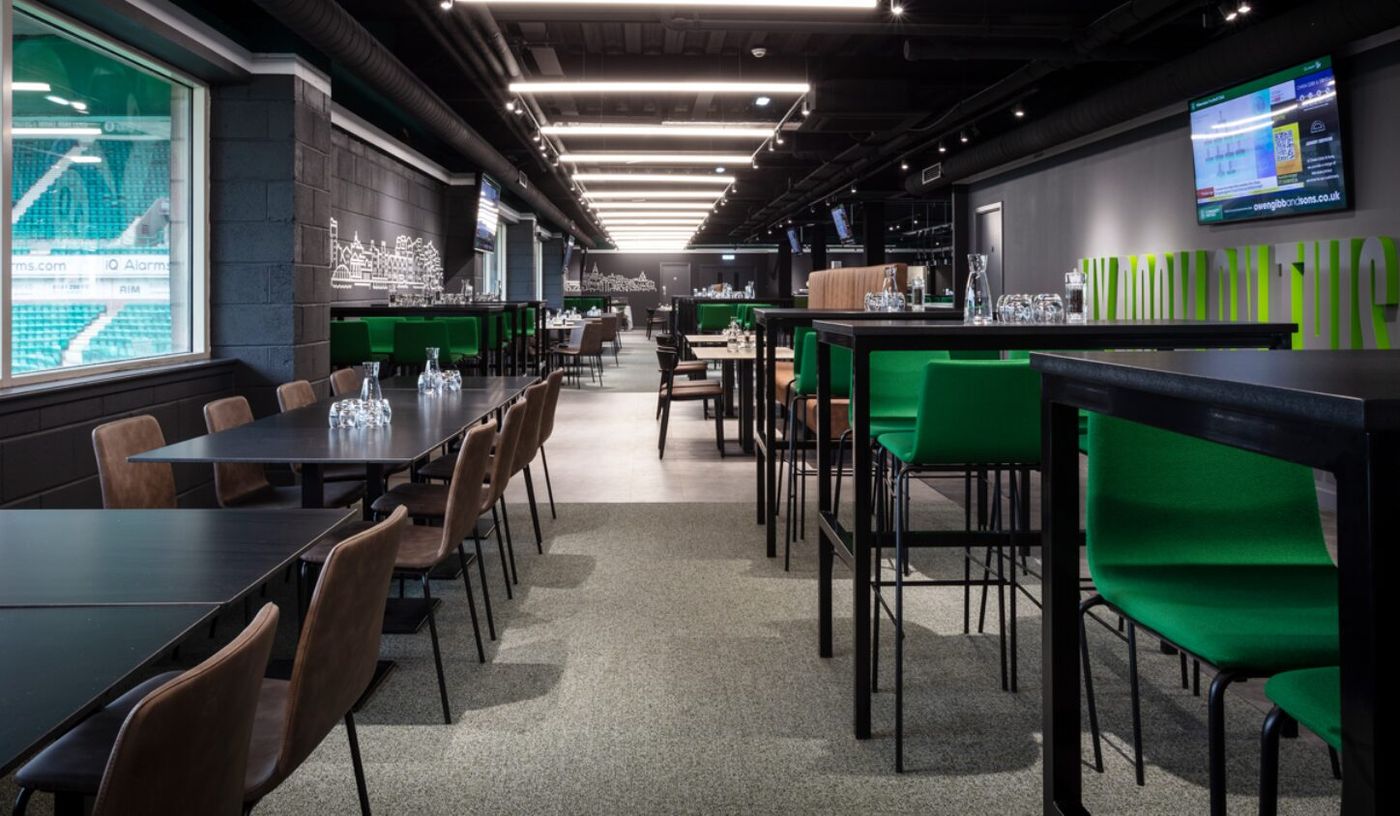 Modern event space at Edinburgh Club, featuring vibrant green seating for networking events.