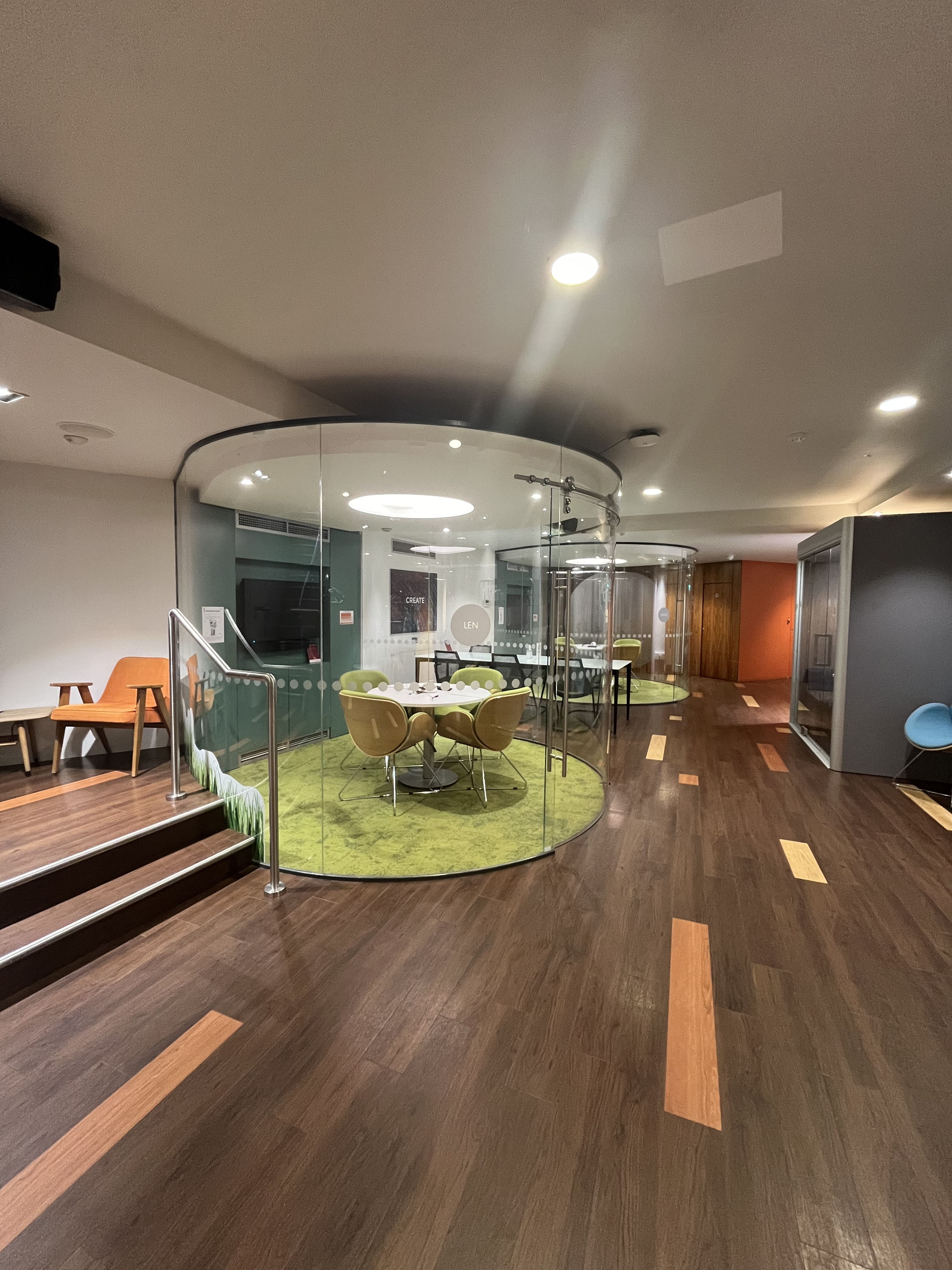 Modern meeting space with glass walls for collaboration at IDEALondon, perfect for brainstorming.