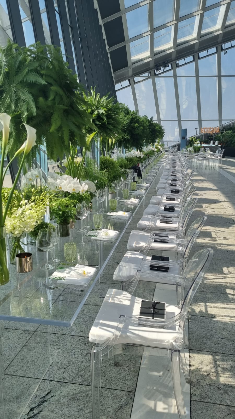 Elegant dining setup at Sky Garden London with floral centerpieces for upscale events.