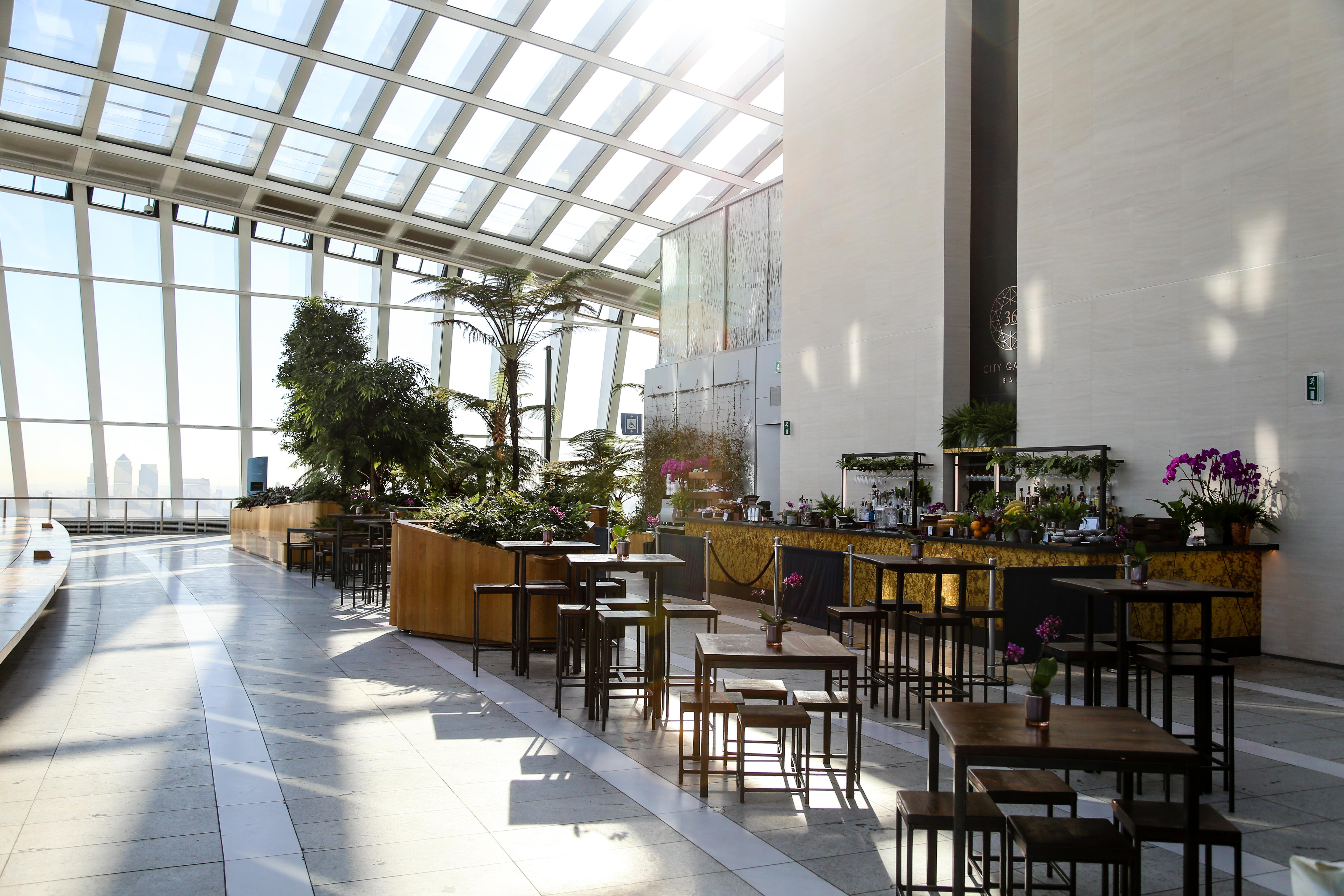 Exclusive hire of Sky Garden London, modern event space with large windows and greenery.
