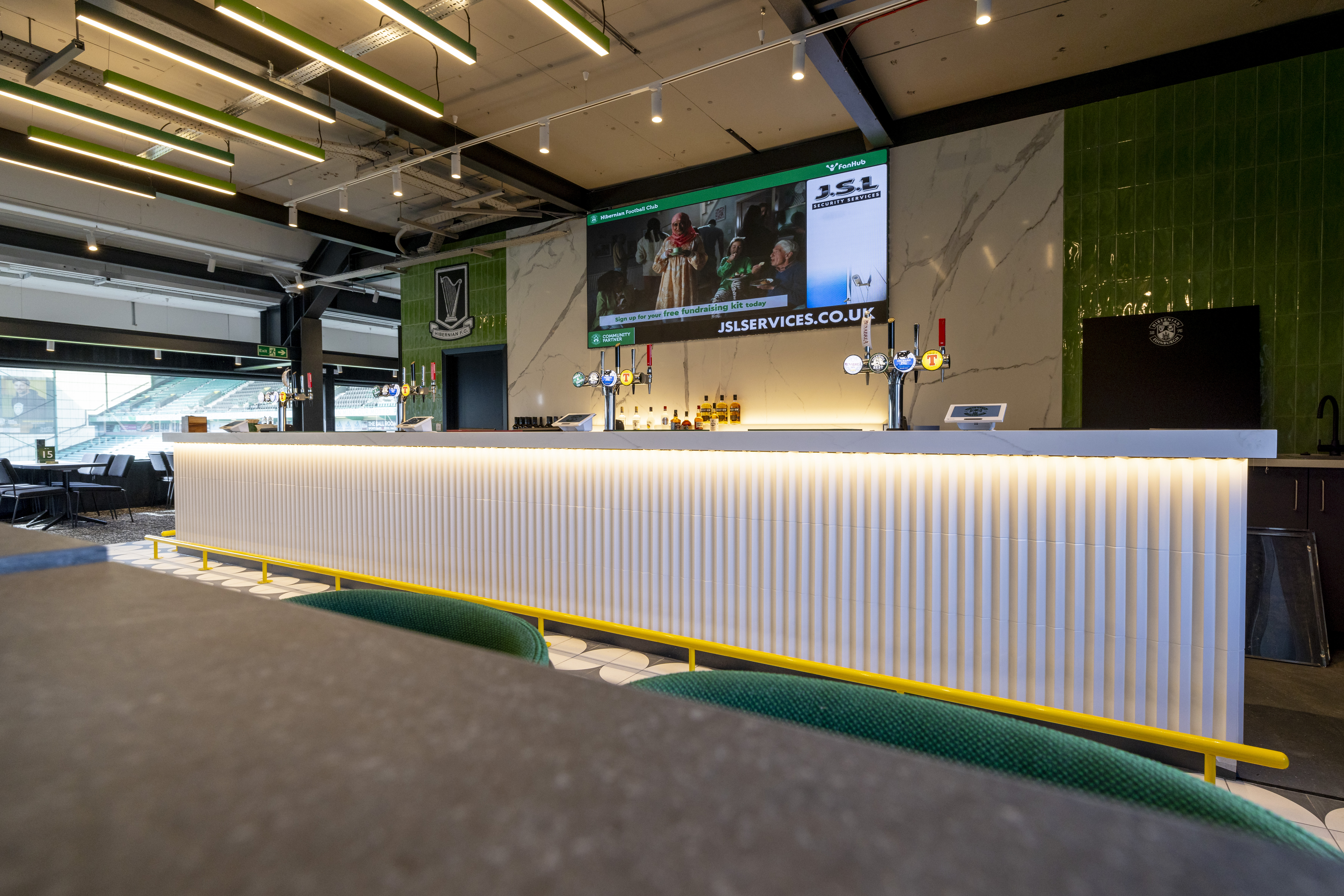 Modern bar setup at Hibernian FC for networking and events, featuring vibrant design.