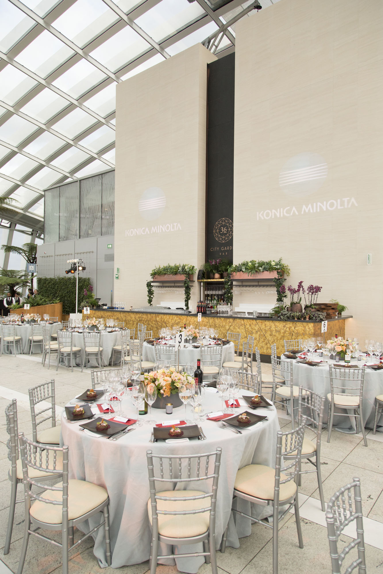 Elegant event space in Sky Garden London with floral centerpieces for corporate gatherings.