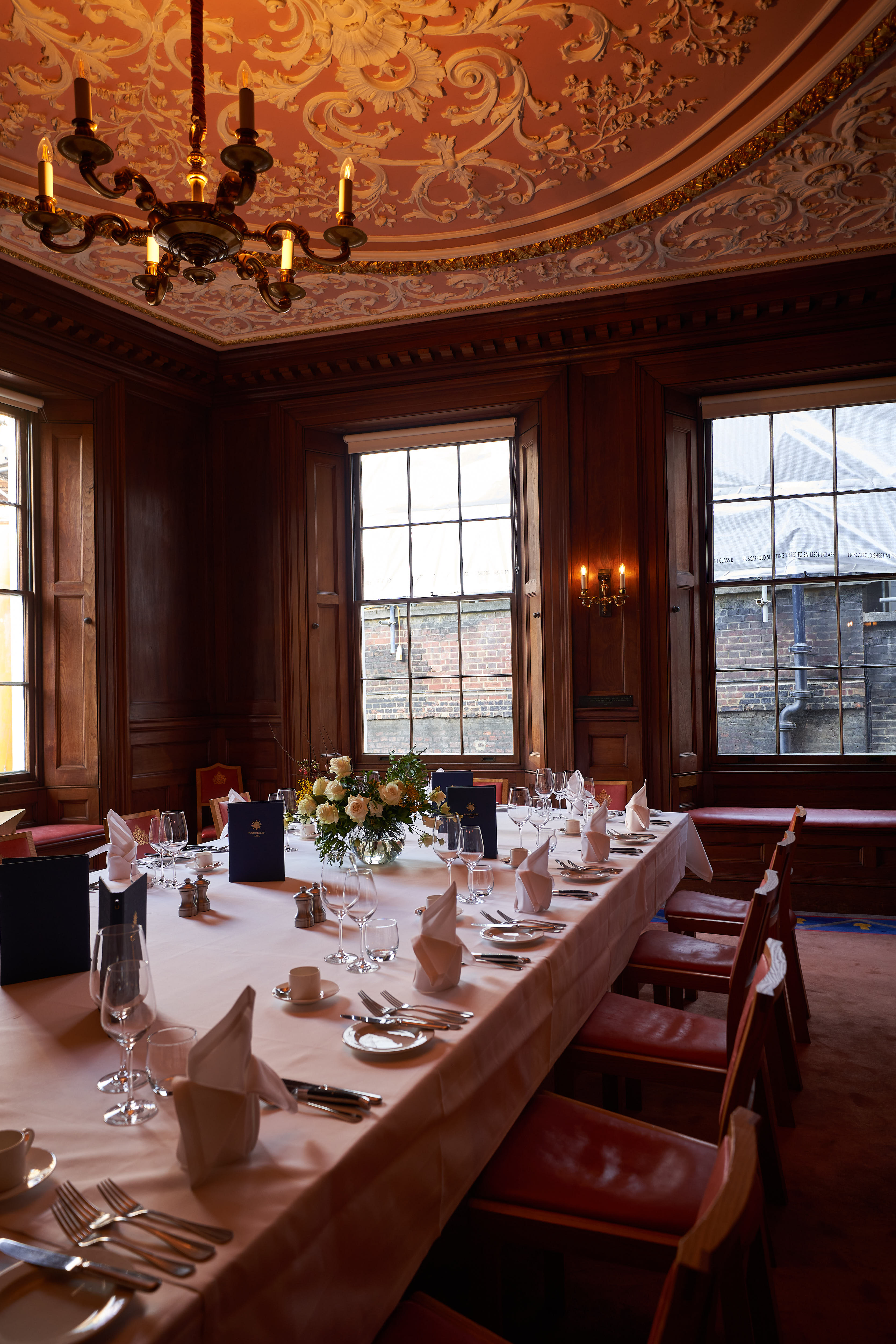 Elegant dining table with floral centerpiece in The New Court Room, perfect for upscale events.
