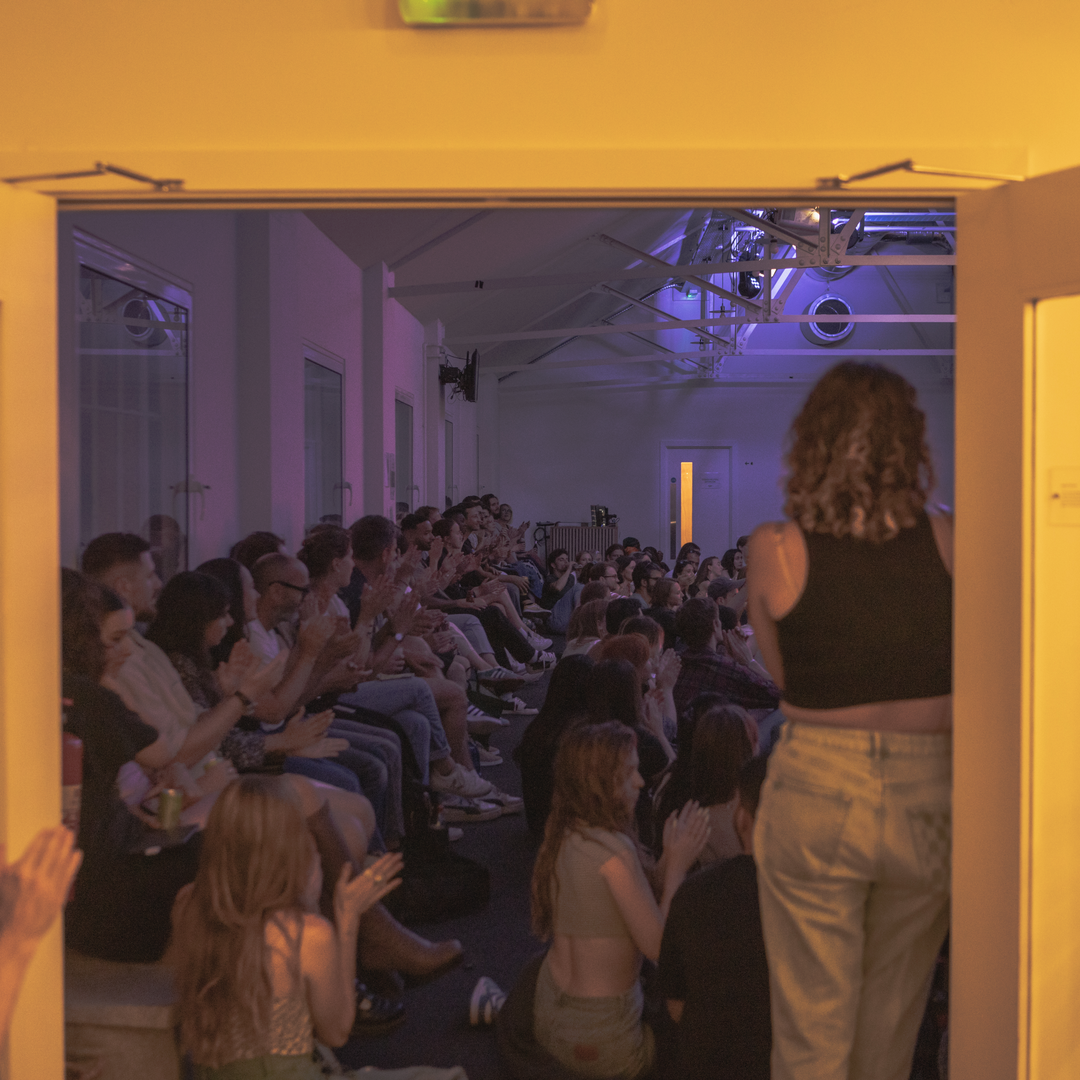 Vibrant audience applauding at a live music hybrid event in King's House.