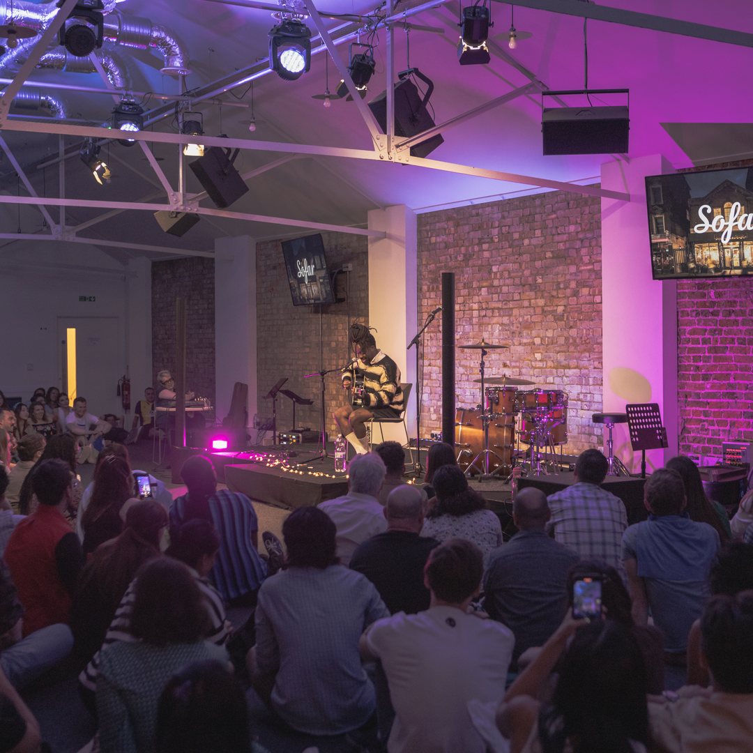 Live music performance at King's House with warm lighting for hybrid events.