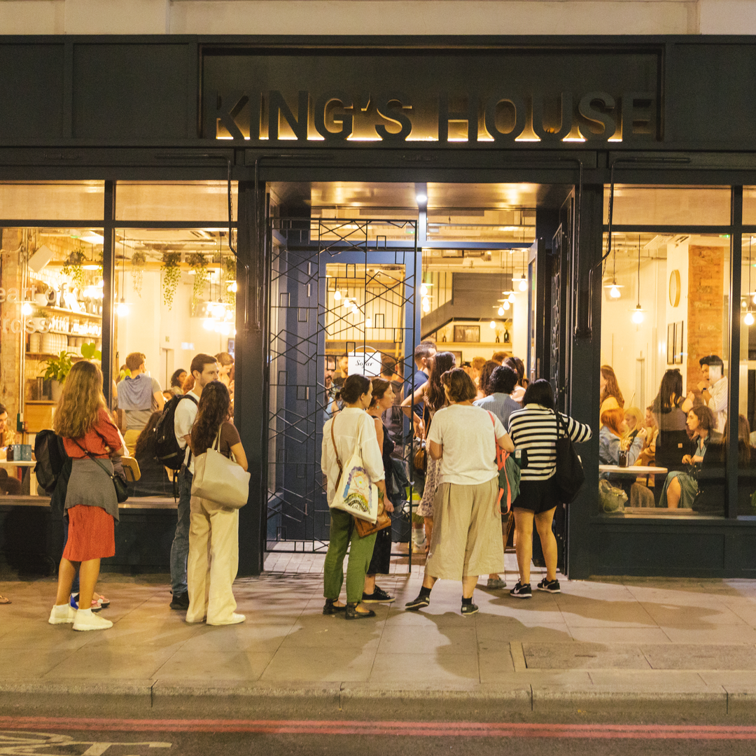 Networking event at King's House with vibrant atmosphere and warm lighting.