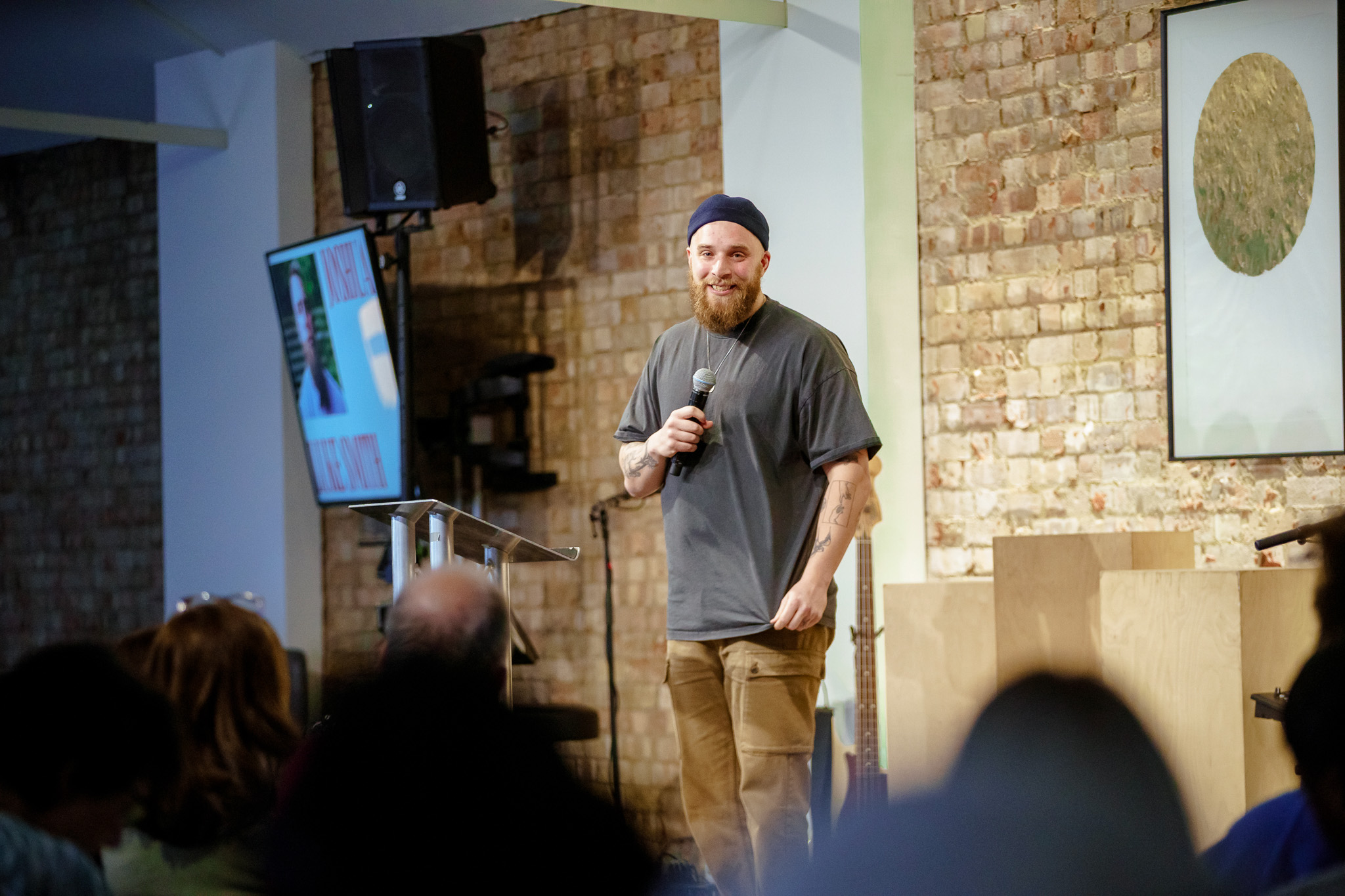 Speaker engaging audience at Networking Charity Fundraiser in modern event space.