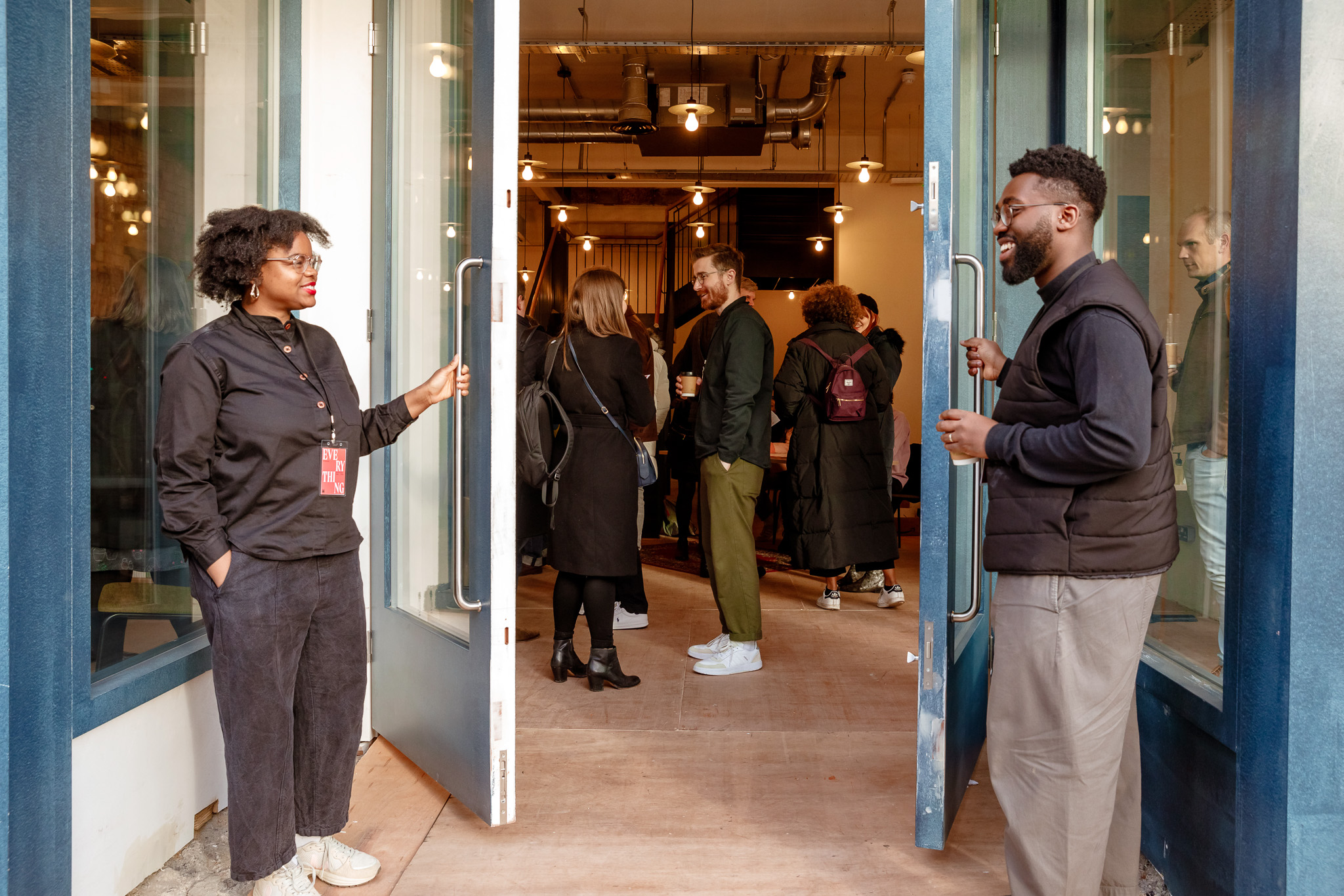 Networking event entrance with attendees engaging at a charity fundraiser.
