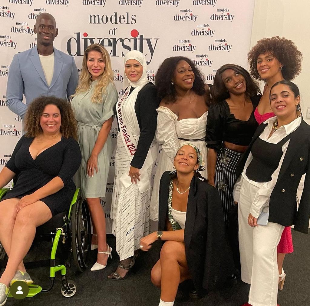 Diverse models at a charity fundraiser promoting inclusivity in fashion and empowerment.