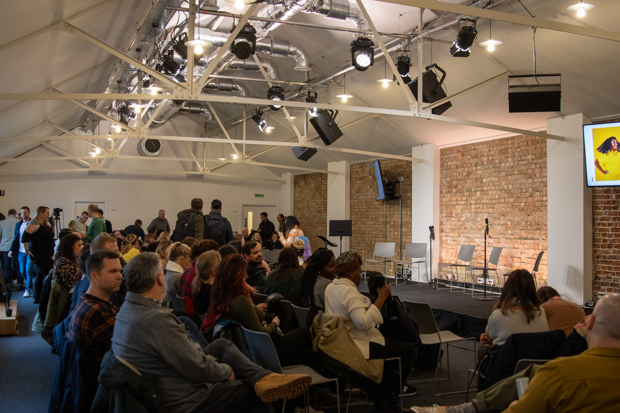 Workshop in King's House with stage, lighting, and engaged audience for successful events.