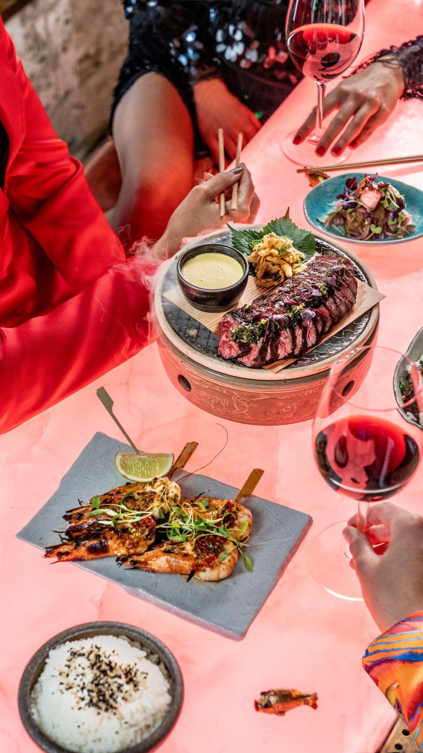 Upscale dining at Sexy Fish Manchester with gourmet steak and red wine.