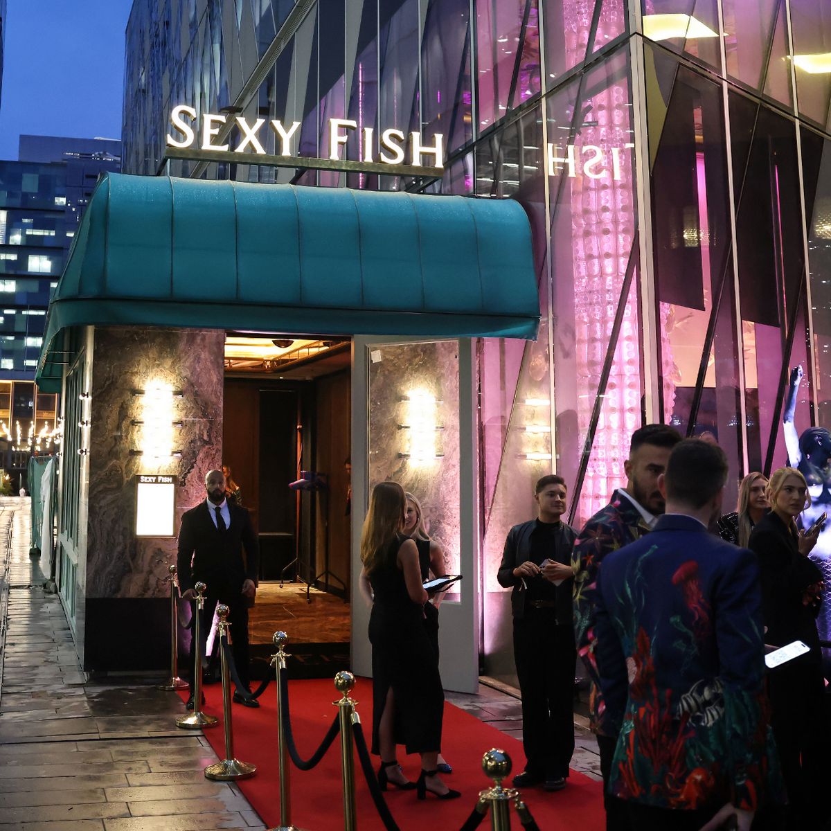 Stylish restaurant entrance at Sexy Fish Manchester with red carpet for exclusive events.
