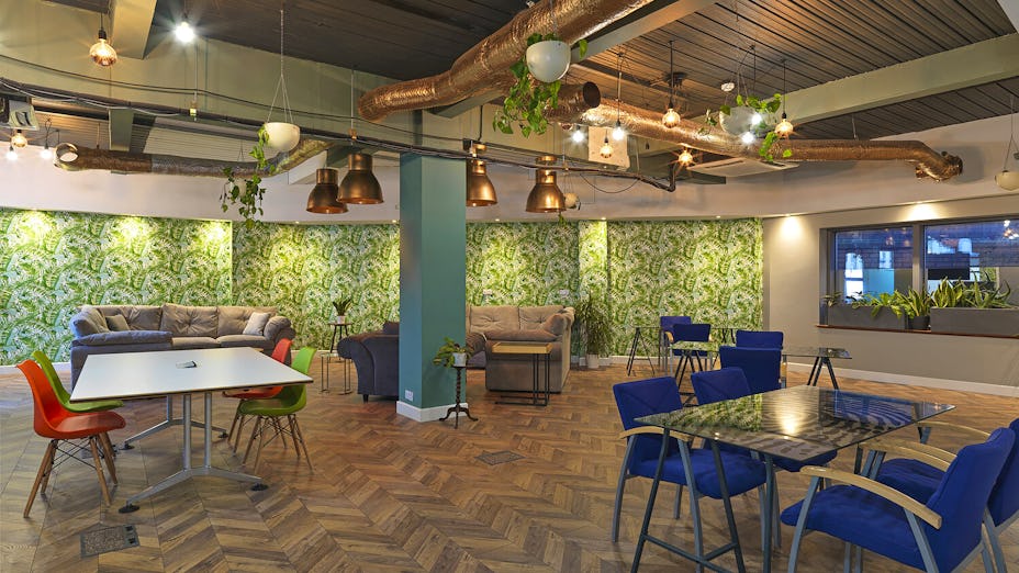 Modern meeting space with greenery, ideal for networking and brainstorming events.