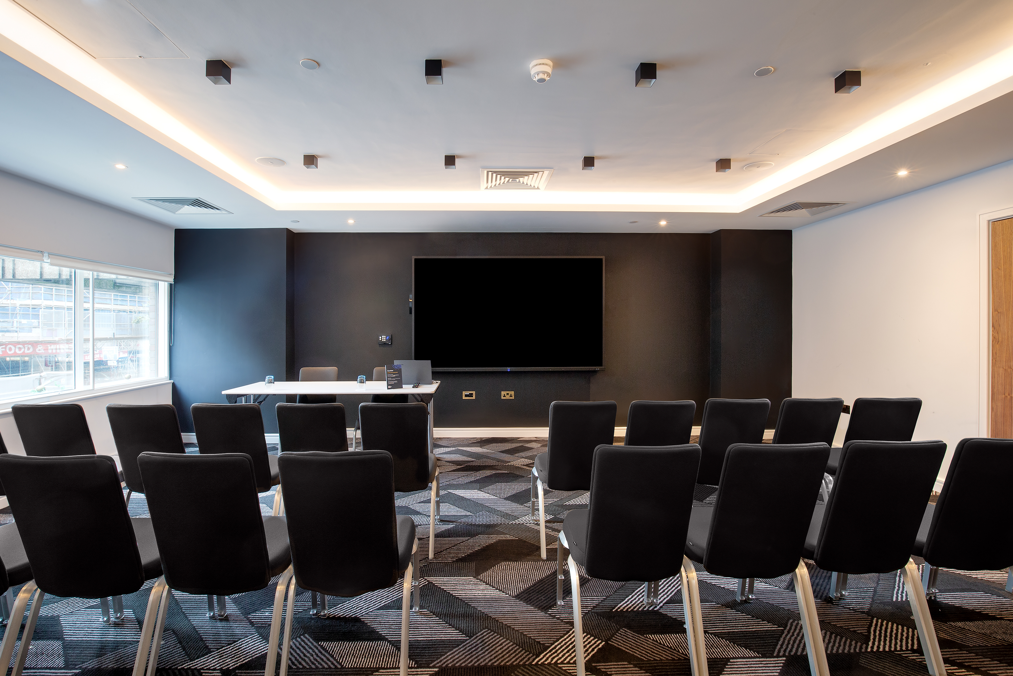 Modern meeting room at Royal National Hotel, ideal for corporate presentations and workshops.