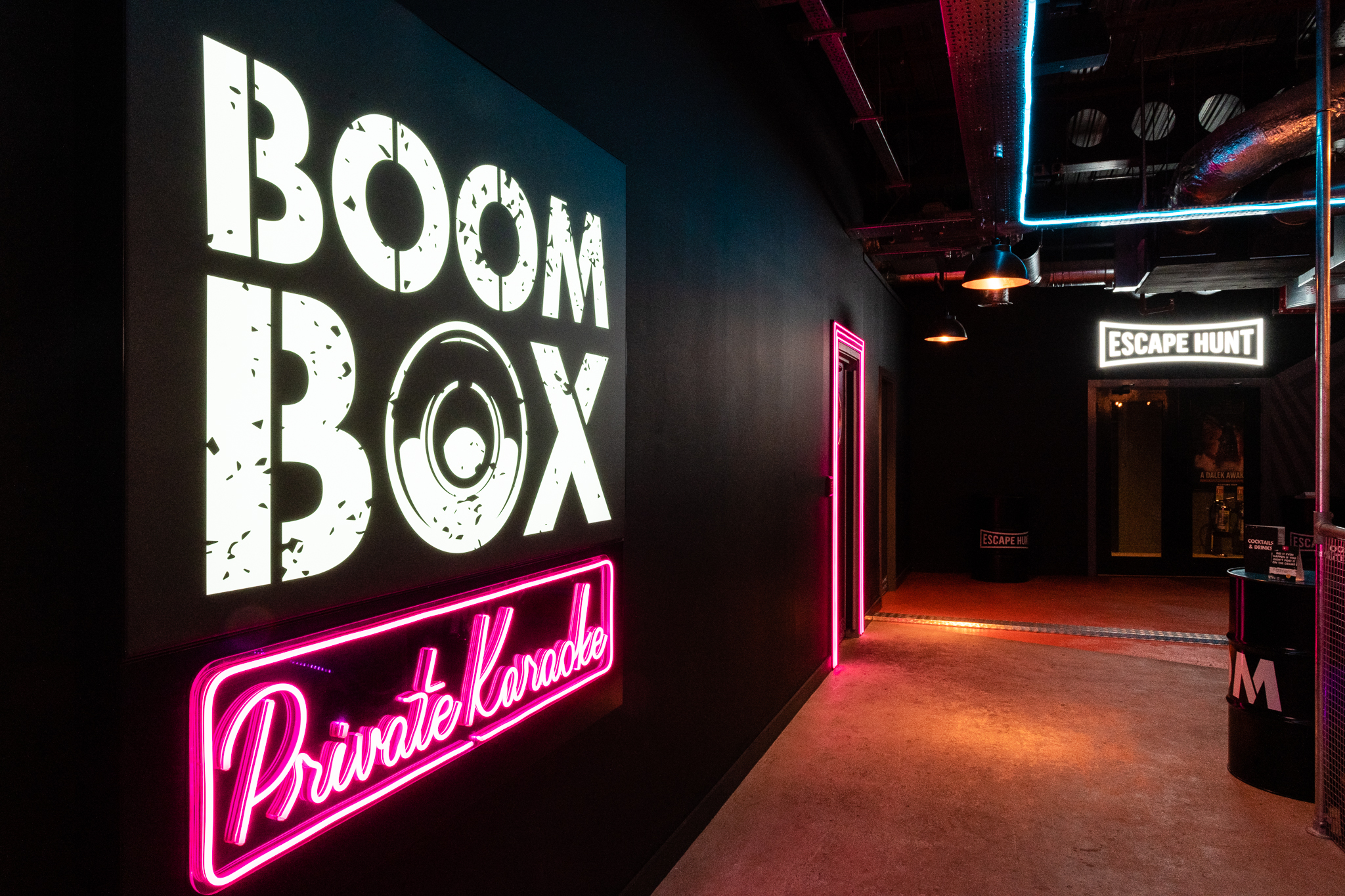 Vibrant Boom Battle Bar entrance with neon lights for team-building events and karaoke.