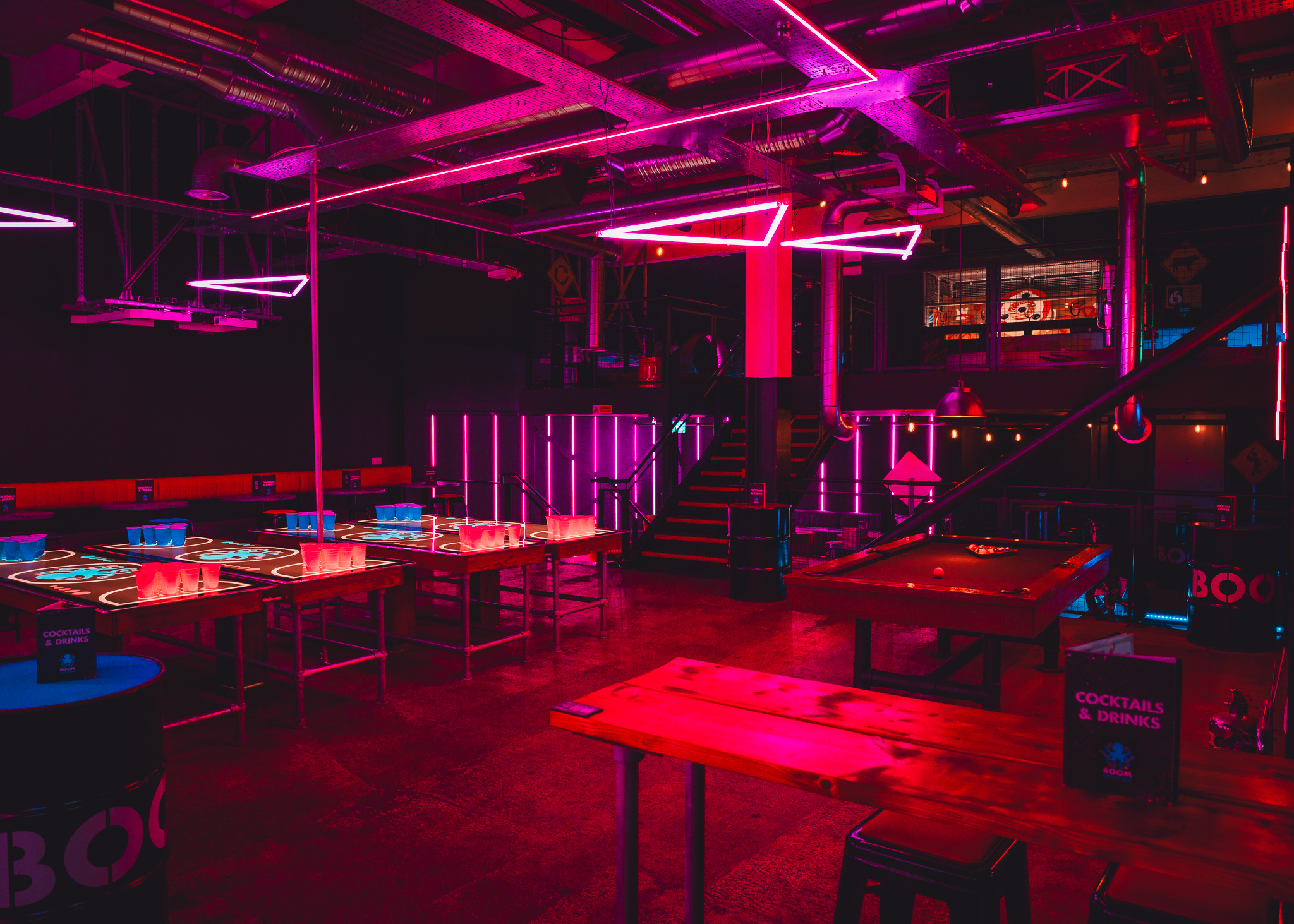 Exclusive private hire event space in Boom Battle Bar Leeds with neon lighting.