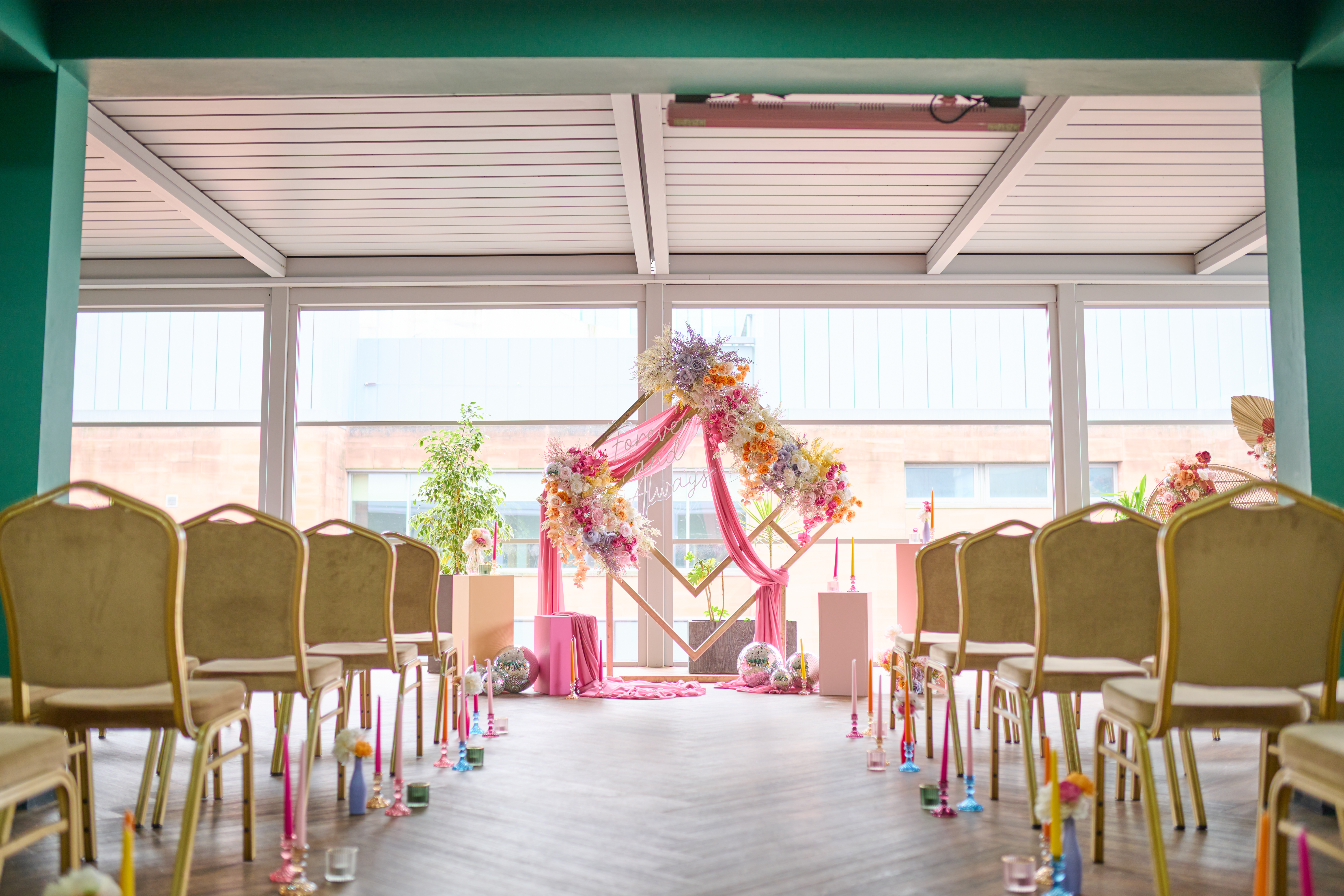 Garden Court in Manchester Hall with floral arch, perfect for weddings and ceremonies.