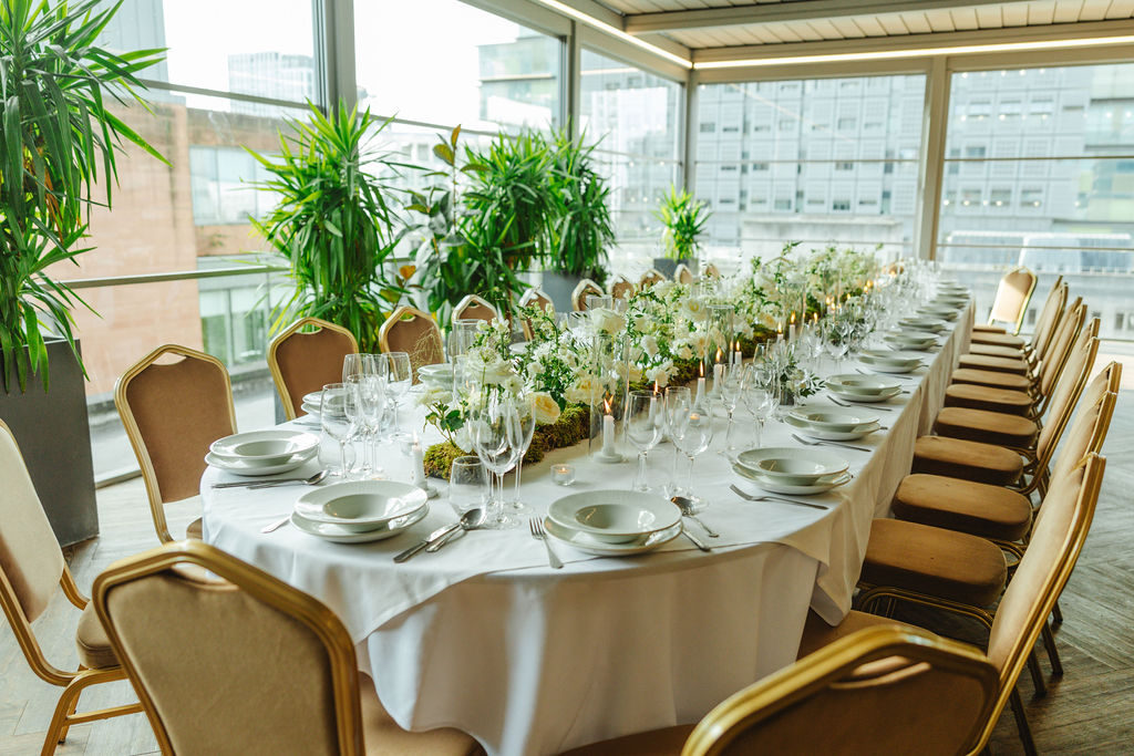 Elegant banquet table in Manchester Hall with fine china and floral centerpieces.