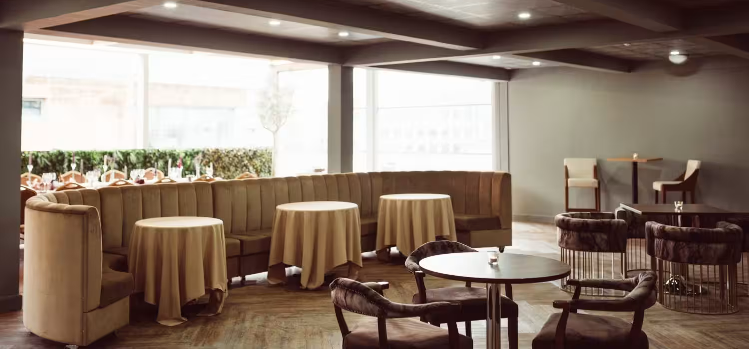 Stylish meeting space in Manchester Hall with cozy booths and natural light.