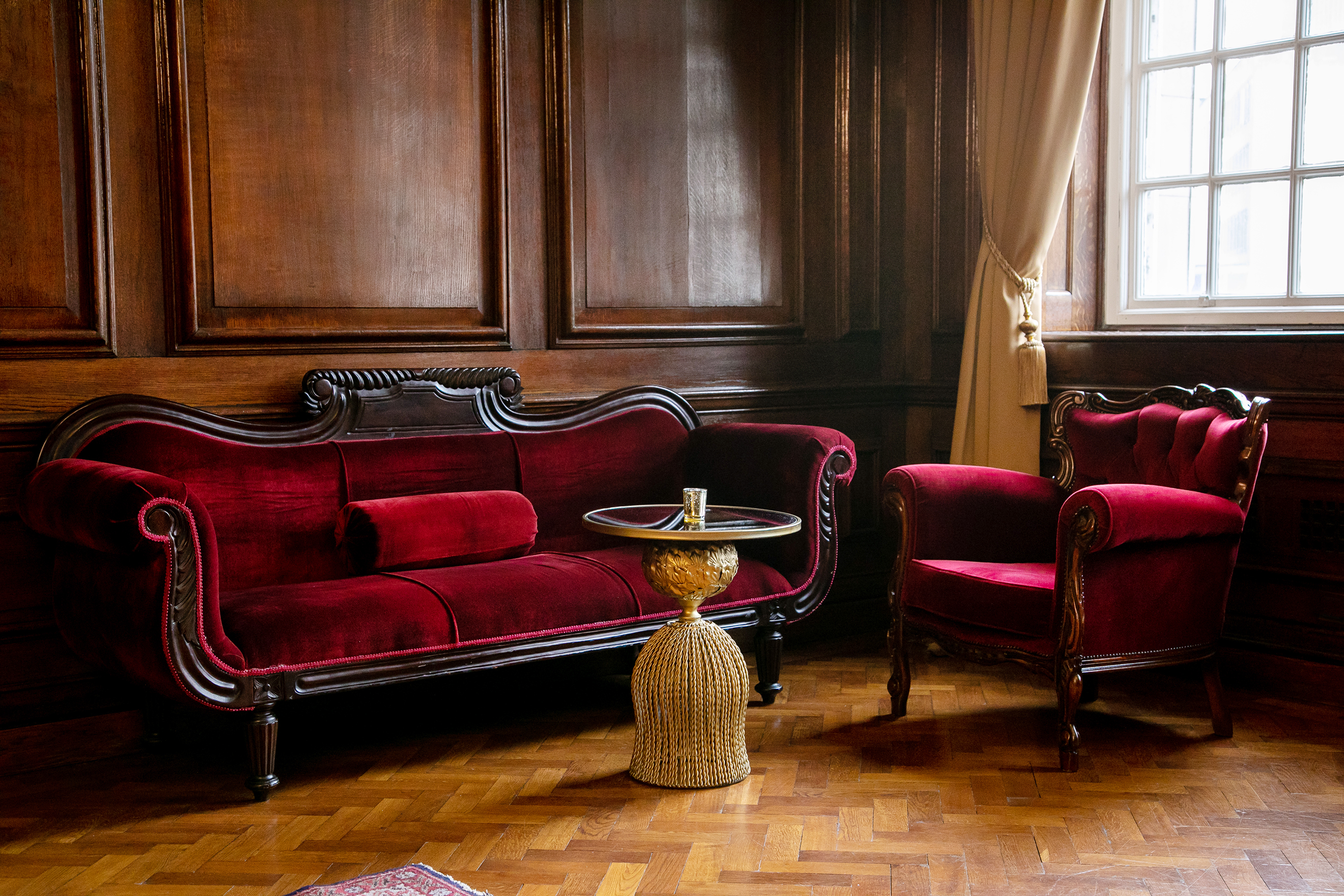 Stylish red upholstered seating in The Club, Manchester Hall for events and meetings.
