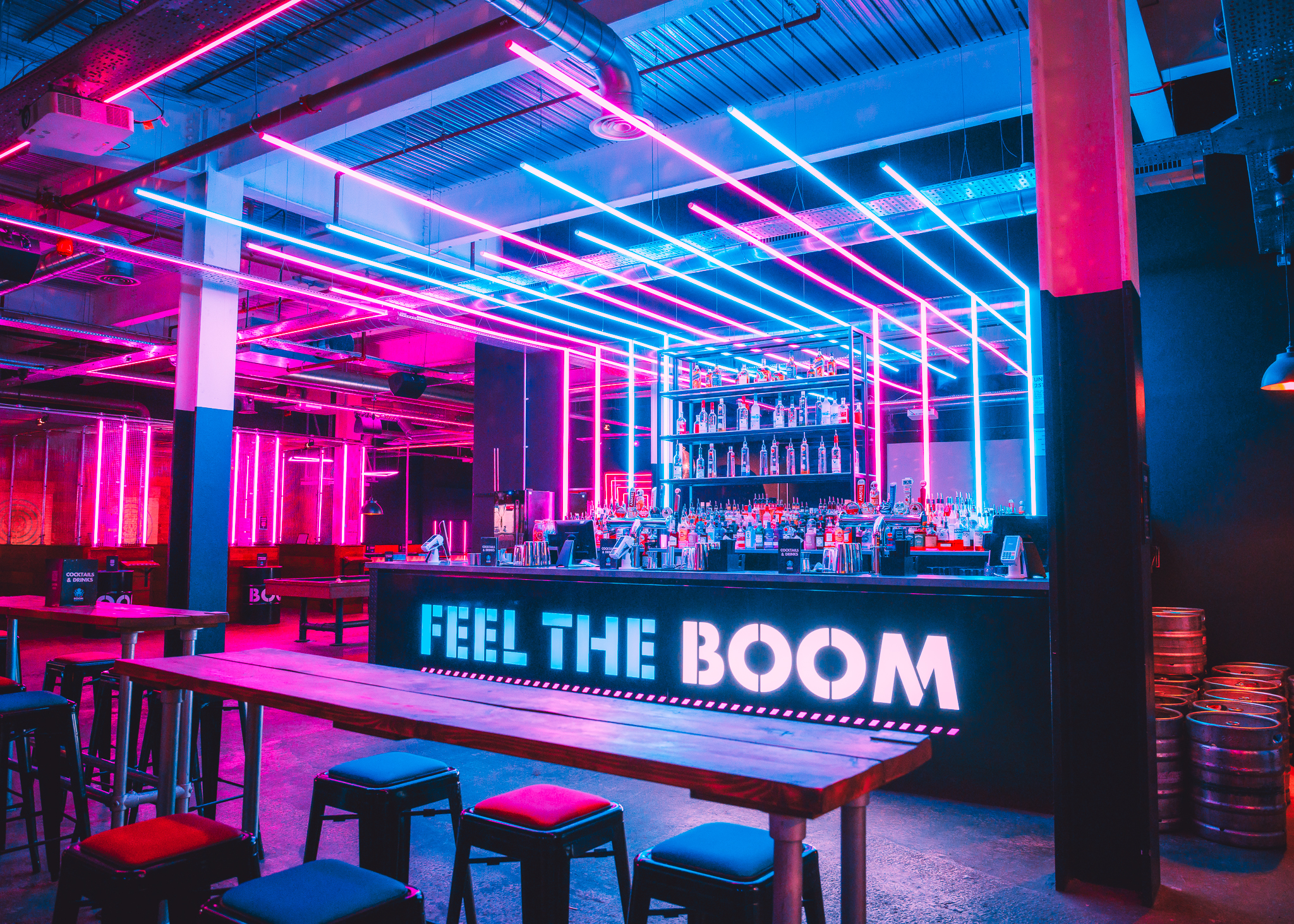 Vibrant event space at Boom Battle Bar Leeds with neon lighting for parties and gatherings.