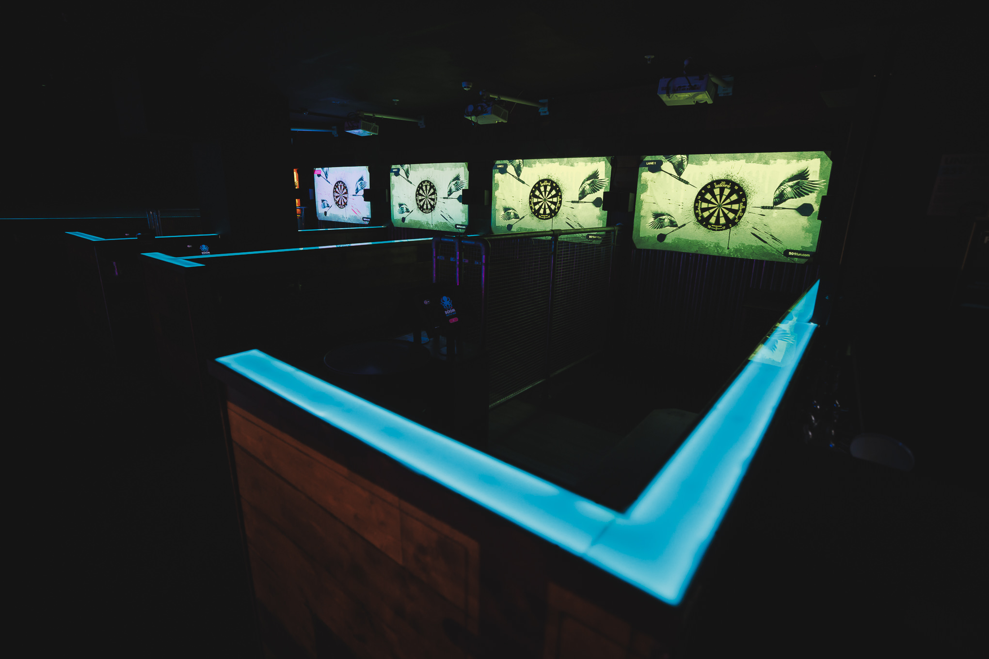 "Modern event space with illuminated bar edges for social gatherings in Boom Battle Bar Manchester."