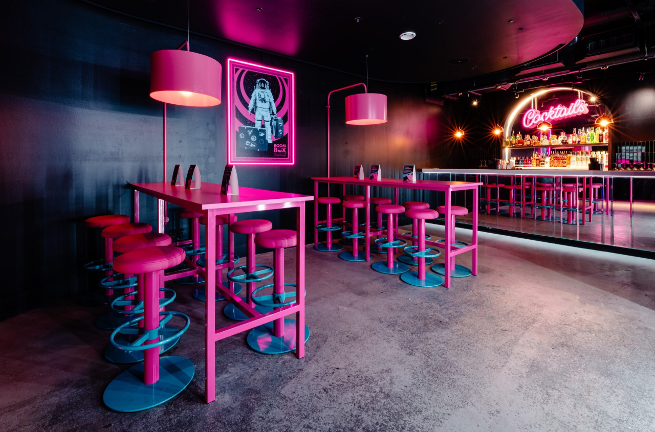 Vibrant event space with pink and blue decor for cocktail receptions at Boom Battle Bar O2.