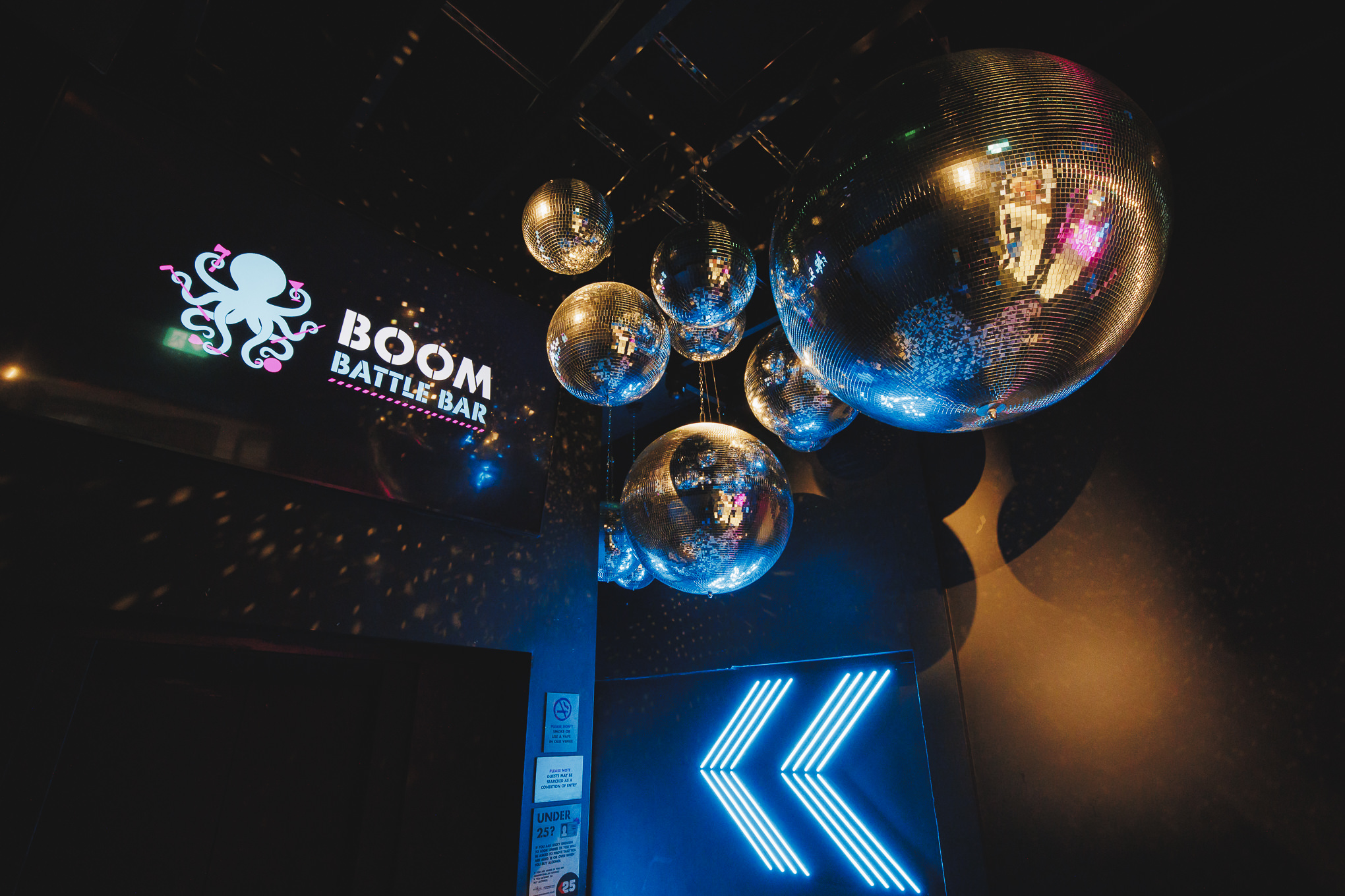Vibrant event space with disco balls at Boom Battle Bar Manchester for team-building events.