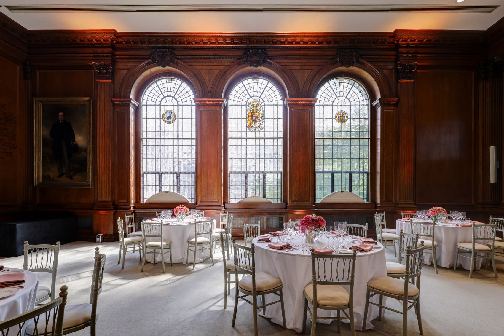 Elegant lecture hall with round tables, perfect for corporate meetings and upscale events.