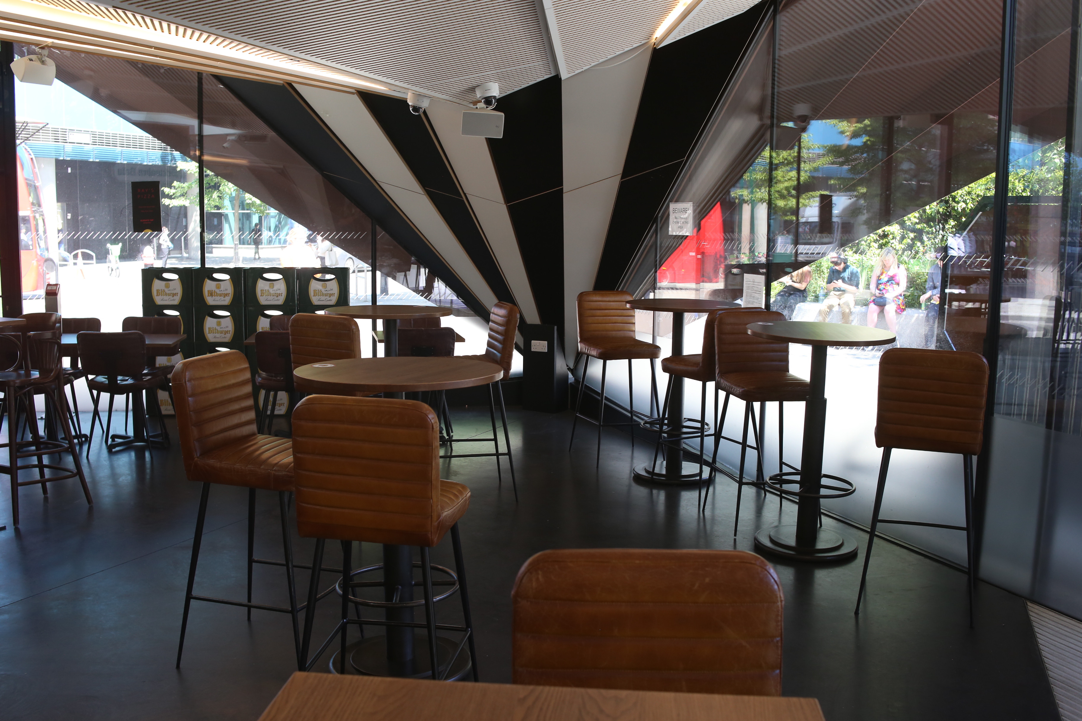 Modern event space in Aldgate Tap with sleek furniture for networking and meetings.