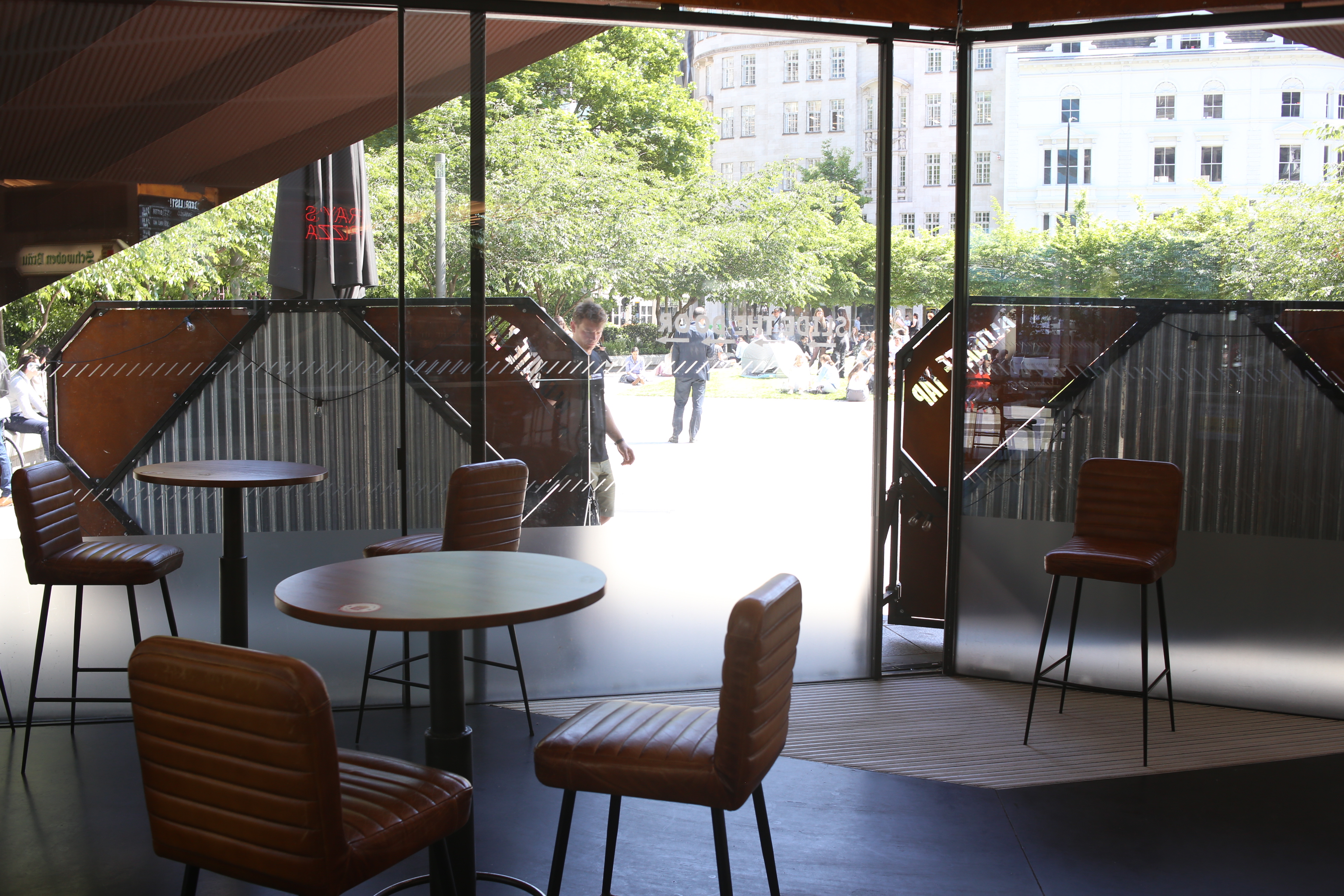 Modern meeting space at Aldgate Tap with large windows, perfect for networking events.