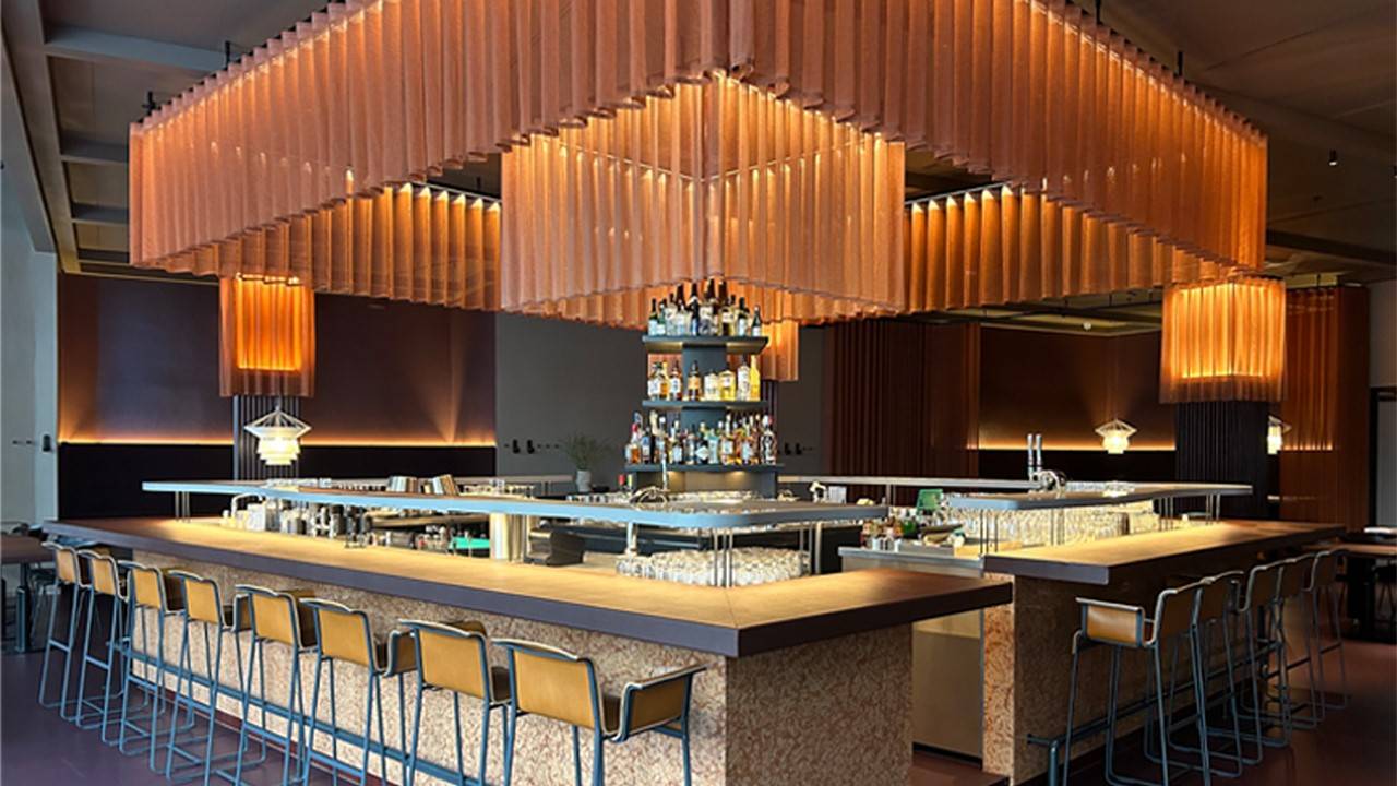 Semi-private dining at Sticks'n'Sushi Shoreditch, modern bar for cocktail receptions.