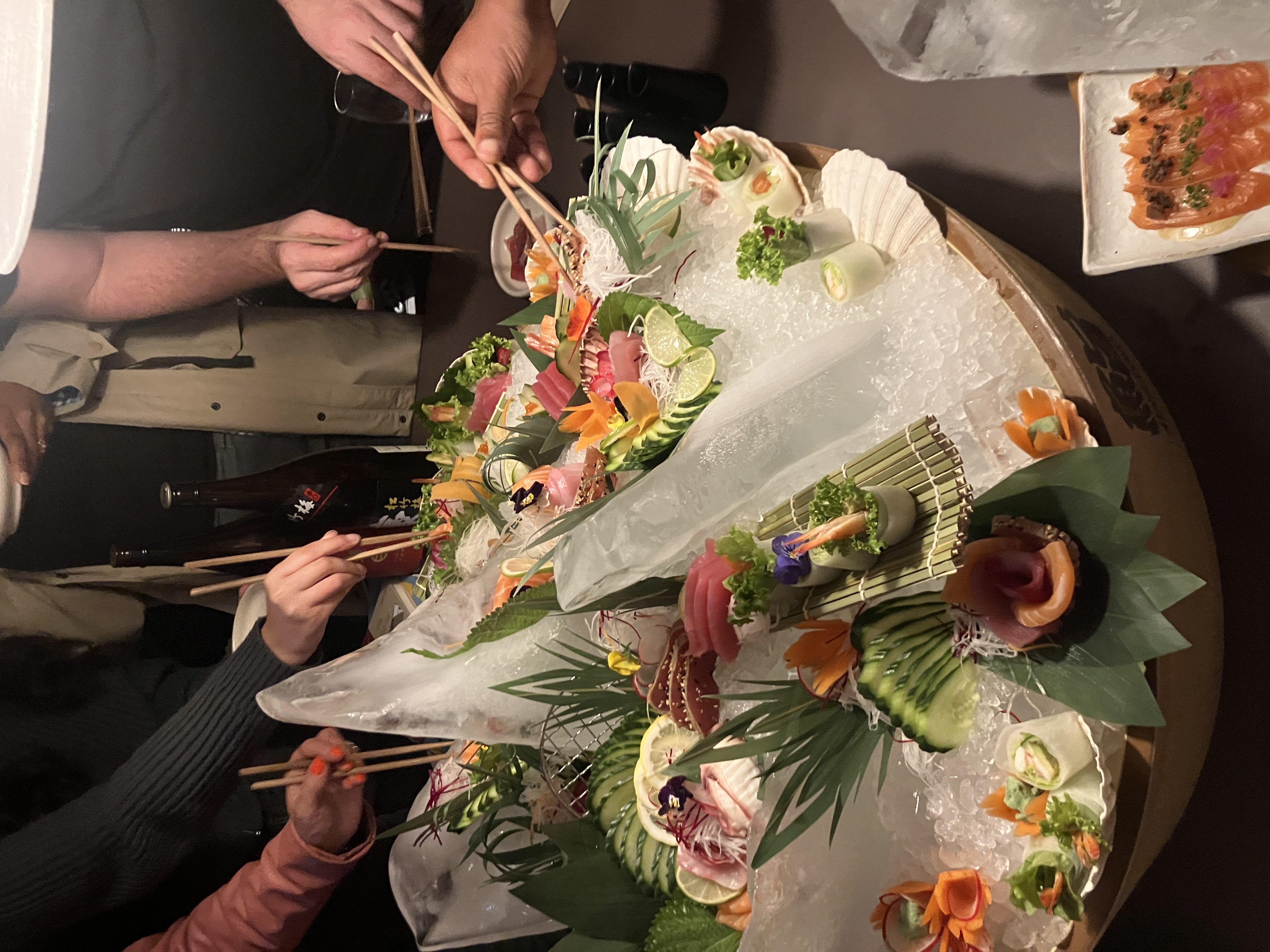 Semi-private dining at Sticks'n'Sushi with vibrant sushi platter for events and networking.