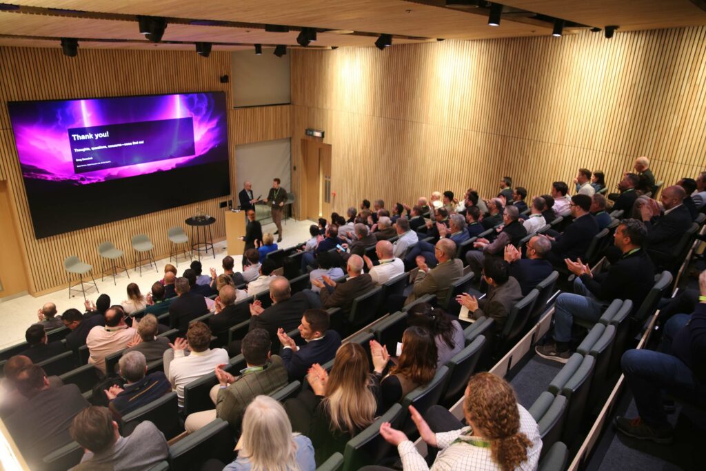 Engaged audience at a modern conference in Think Tank, 8 Bishopsgate, London.