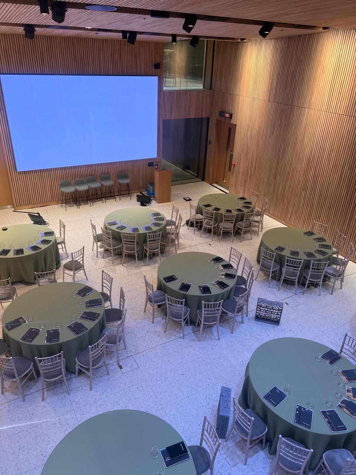 Event space at 8 Bishopsgate with green tablecloths for meetings and conferences.