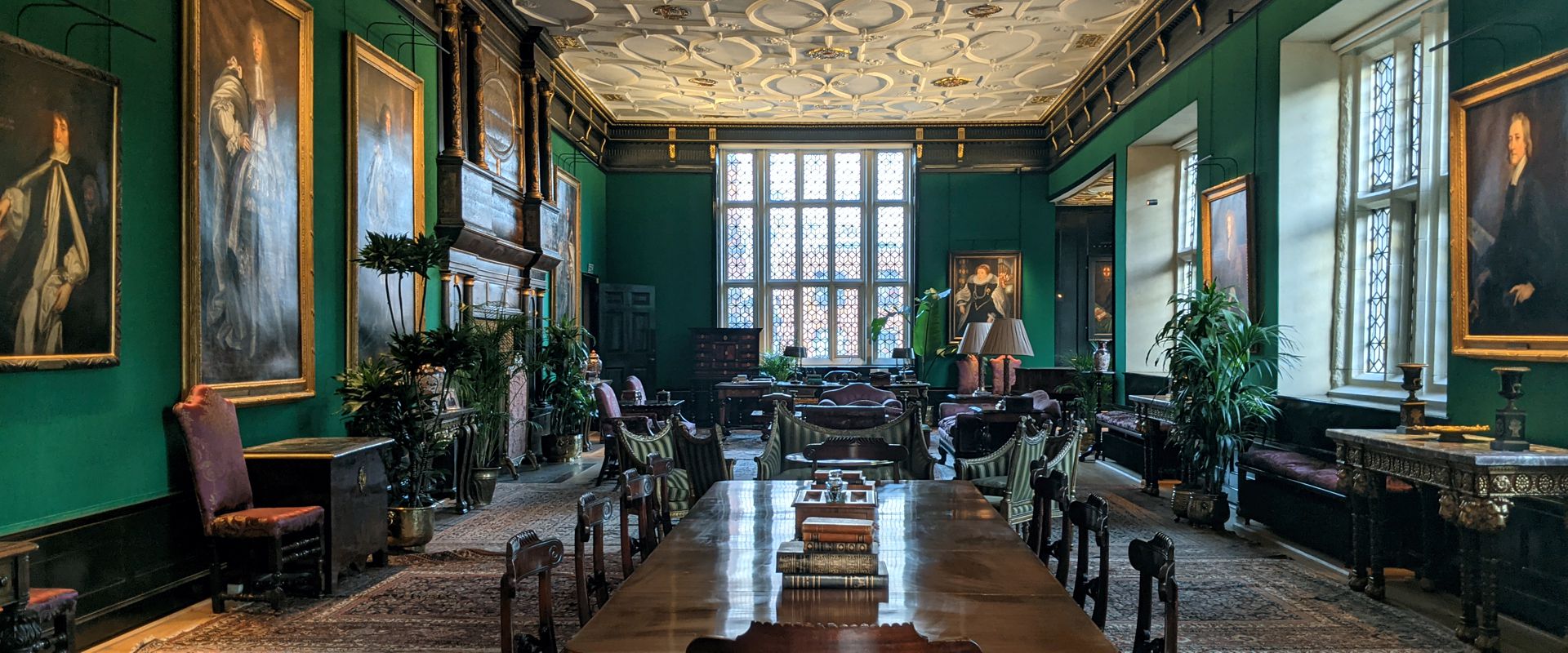 Great Chamber in The Charterhouse, elegant green walls, ideal for meetings and events.
