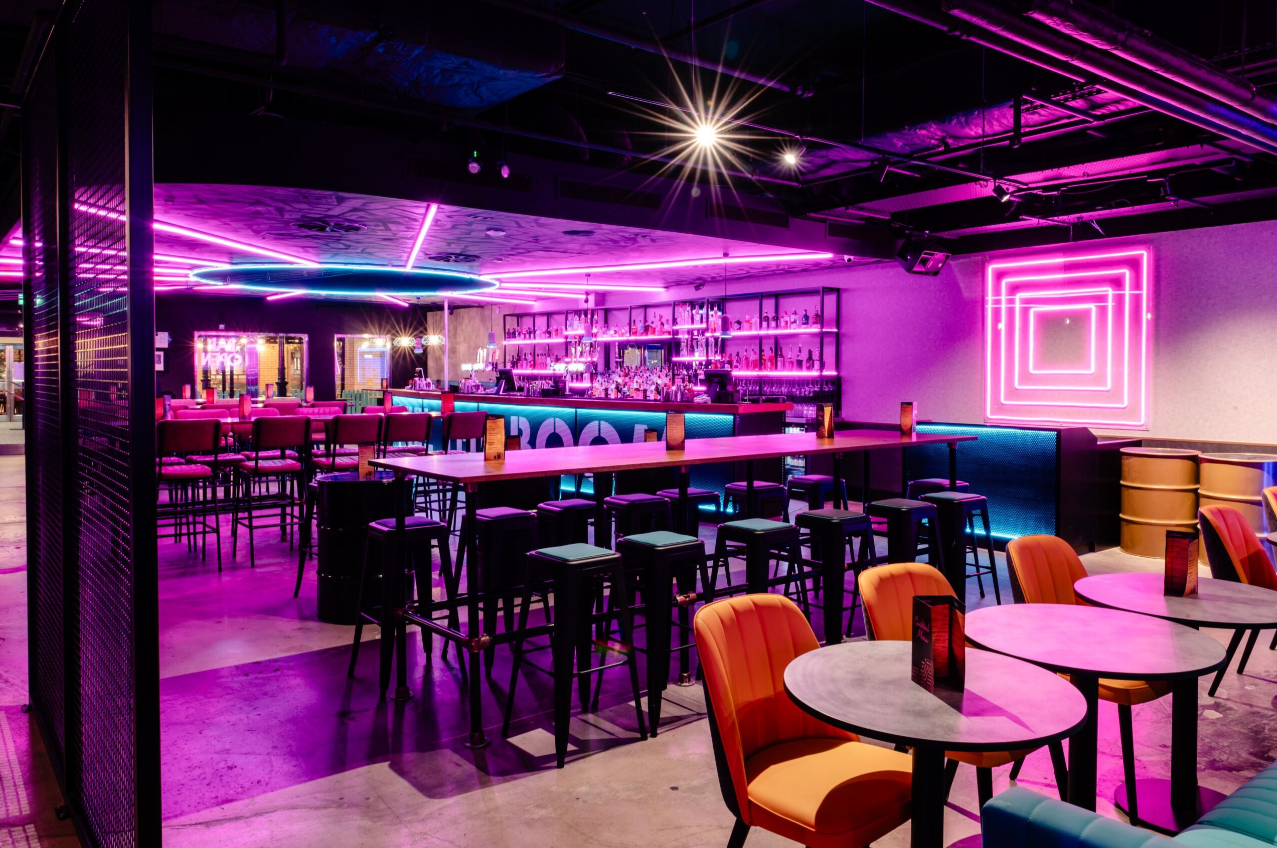 Vibrant event space with neon lighting for private hire at Boom Battle Bar O2.