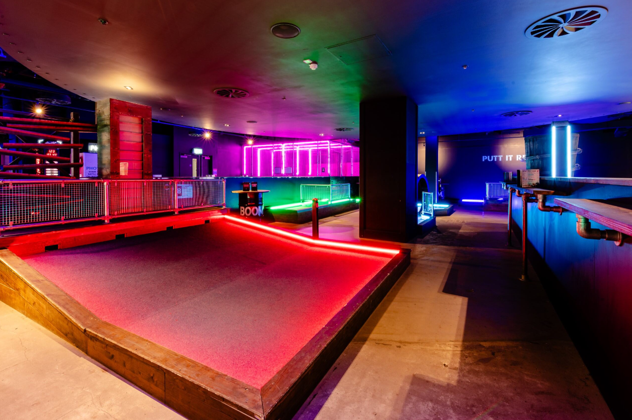 "Vibrant event space with neon lighting for team-building at Boom Battle Bar O2."