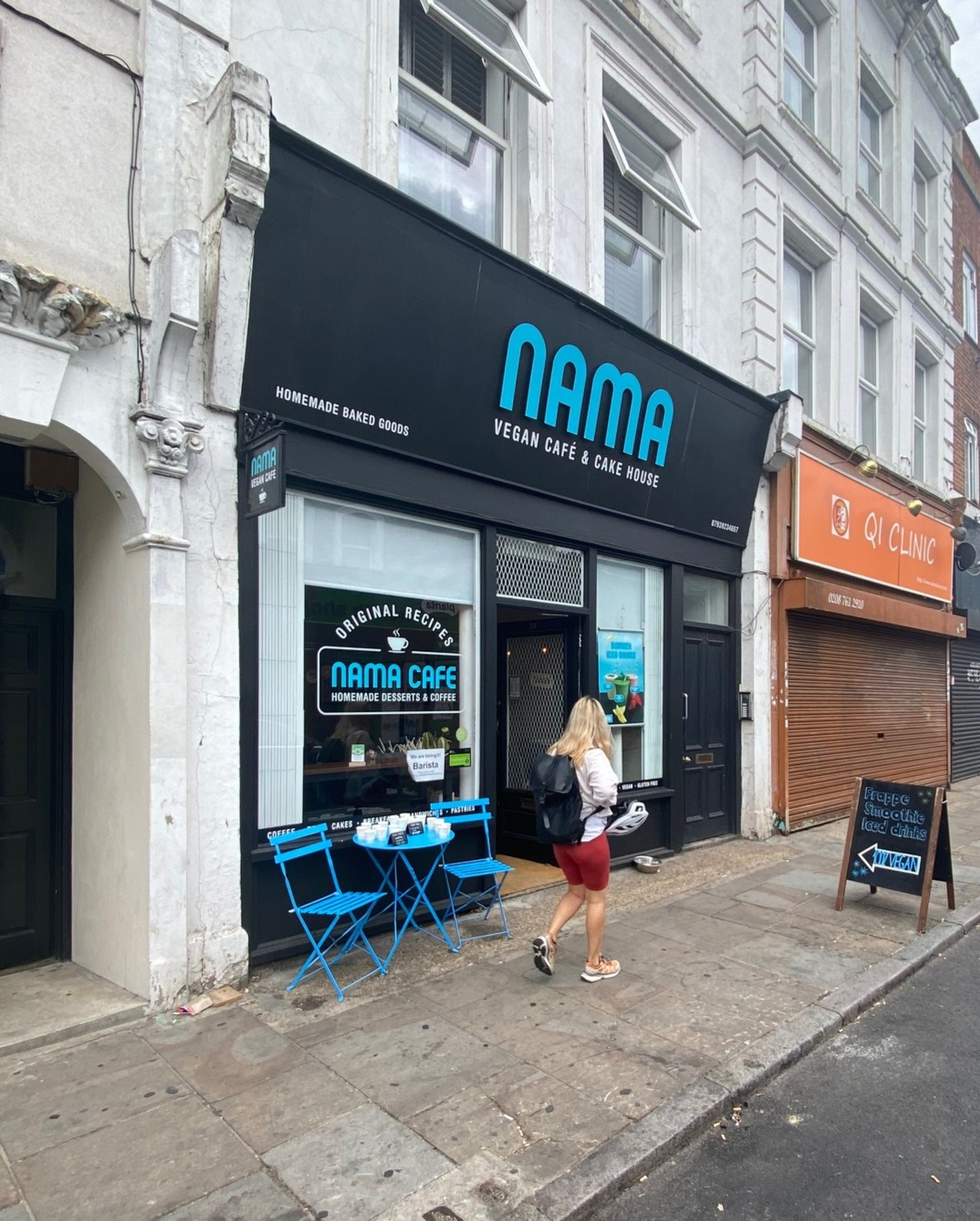 Vegan café storefront with outdoor seating, ideal for casual networking events.